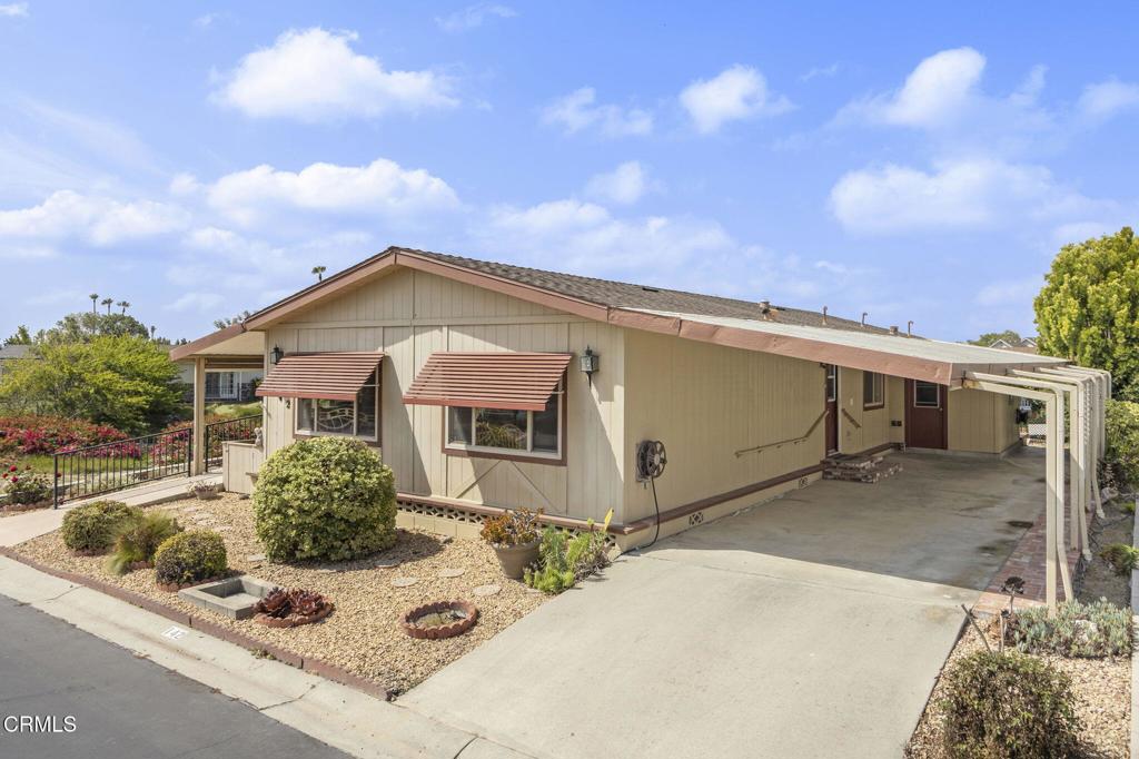 Welcome to Poinsettia Gardens, Ventura's premiere, over 55 community where you own the land and pay low monthly HOA dues of $357. One of the best locations within the community as the Clubhouse, pool, spa is directly across the street and views of the pond from the front patio- yes, it's a waterfront home. This updated home includes an open floorplan with kitchen offering warm honey oak cabinets, granite countertops, island with sink, stainless appliances included with ascents of glass cabinet faces. The kitchen opens to the southern exposure / light and bright living room with vaulted ceilings, neutral tones, hardwood flooring throughout, slider to front porch, and more. The primary suite offers an additional bonus room perfect for home office, crafts, or workout room, walk-in closet, and in-suite bathroom. The secondary bedroom is ample in size. Carport with built-in storage room that offers additional storage space, washer and dryer included, ceiling fan, central A/C, dual pane windows, and a lot more to offer.
