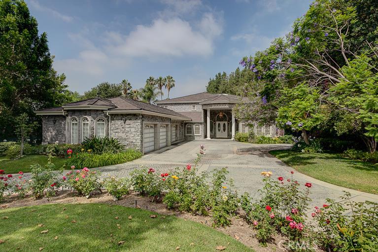 This luxury mansion is a rare find! This custom-built, gated luxury mansion offers 8953 square feet, with a spacious main house (5BR/7BA), a separate 599 square feet 1 BR/1BA guest house, a swimming pool, koi fish pond, beautifully landscaped garden. Additional highlights include two-story-high foyer, grand living room, huge family room, formal dining room, separate family dinning room, gym/game room, library, pets room, fish pond & fountain, 3 fireplaces, 2 wet bars, sauna, indoor spa tubs, soaring ceilings, crystal chandeliers, newly updated kitchen with center island, 2 Sub Zero refrigerators, 2 dishwashers, custom made drapery & carpets, and lots of tailored built-ins and design details. All bedrooms have own attached bathrooms. Two upstairs bedrooms both have large balconies overlooking the park-like backyard. Attached 4-car garage plus over 200 square feet of extra storage space. 4 units of A/C in the main house. Built-in BBQ griller, perfect for outdoor entertaining. This is truly a gracious home for comfortable living and entertaining.