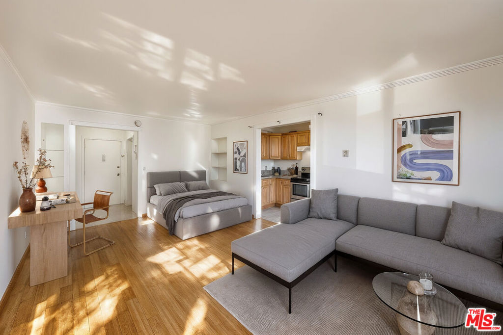 Bask in the rhythm of city life in this sunlit Koreatown studio, where modern style meets the energy of Los Angeles' most dynamic neighborhood. The updated kitchen features sleek granite countertops, rich wood cabinetry, and stainless-steel appliances that make cooking both functional and enjoyable. A cozy dining nook sits nearby, perfect for morning coffee, quiet meals, or entertaining friends. Warm wood flooring enhances the main living area, creating a welcoming and open feel, while the entryway offers plenty of space for shoes, bags, and daily essentials. A spacious closet with mirrored sliding doors provides ample storage and adds depth to the space. The bathroom features a modern vessel sink and thoughtfully designed shelving for extra organization. Step outside to your private balcony overlooking the lively street below, ideal for enjoying fresh air and LA sunshine. One dedicated parking space adds extra convenience. Situated in the heart of Koreatown, you're surrounded by some of the city's best restaurants, nightlife, and entertainment, including The Wiltern and world-famous Korean BBQ with a short distance to Downtown LA and West Hollywood.