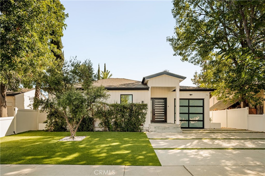 Presenting a newly remodeled residence nestled in the heart of Encino, this modern home blends timeless comfort with contemporary elegance. Set on a 5,504 square foot lot. The property offers 4 bedrooms and 3.5 bathrooms. Step inside to discover an open floor plan enhanced by wide-plank hardwood flooring and sleek modern finishes. The family room is anchored by a custom entertainment console and seamlessly flows to the adjacent kitchen. Designed with both style and function in mind, the chef’s kitchen boasts a large center island with seating, stainless steel appliances, and custom cabinetry. The living room is highlighted by an expansive sliding glass door, creating effortless indoor-outdoor living. The primary suite is a serene retreat, featuring direct access to the backyard, a spacious walk-in closet, and a spa-inspired bathroom. Wrapped in marble, the bath includes dual vanities, a soaking tub, and a glass-enclosed shower, offering the perfect setting for relaxation. The outdoor space is surrounded by lush greenery, creating both privacy and tranquility. A spacious grassy lawn, built-in BBQ, and multiple entertaining areas provide an ideal backdrop for gatherings with family and friends. Conveniently located just moments from Ventura Boulevard’s premier shops, dining, and entertainment, this residence also offers easy access to the Balboa Sports Complex, Trader Joe’s, and the 101 and 405 freeways. This Encino residence combines modern amenities, stylish design, and a prime location to deliver an exceptional living experience.
