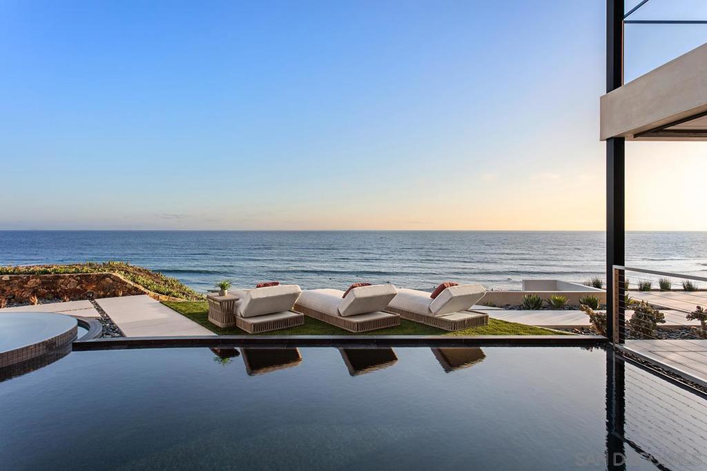 Newly Priced!! Captivating waterfront view, with striking modern design and uncompromised luxury combined in this new 5BD, 5 full BA + 3 half BA, 8,878-sf property, known as the ORA House. From the award-winning firm, Blue Heron, known for biophilic design, the brilliant integration of natural elements and indoor-outdoor living create harmony with the surrounding oceanside environment Restorative and inviting, the ORA house exemplifies what is possible when world-class designers unleash their creativity on the scenic jewel of La Jolla. Blue Heron, a nationally recognized and award-winning visionary and experiential firm, has designed and developed its second unmatched custom home in La Jolla. The contemporary and sustainable home design provides a unique setting with a view looking south to Crystal Pier, Point Loma, and the Coronado Islands and west to the sunset. 5228 Chelsea, "The ORA House", provides an unmatched modern living experience with a design that has maximized utilization of the lot and vertical space. The home offers a dramatic entry over a floating bridge leading to to an expansive ocean view, led by fire and a pool spilling down two water walls into multiple vertical voids over the lower living area and entering an all gas foyer where the beach pebbles flow inside to dissolve indoor / outdoor boundaries. The master suite has been purposely laid out wide to maximize the sublime views with glass at the vanity and beyond the bed wall to allow for ocean views from every angle, and includes a private heated balcony, oversized master closet with laundry and a gorgeous steam shower. A roof top entertainment space hosts magnificent 180-degree ocean views, and is complete with heaters, fire pit, BBQ, a wall of television screens and powder room.