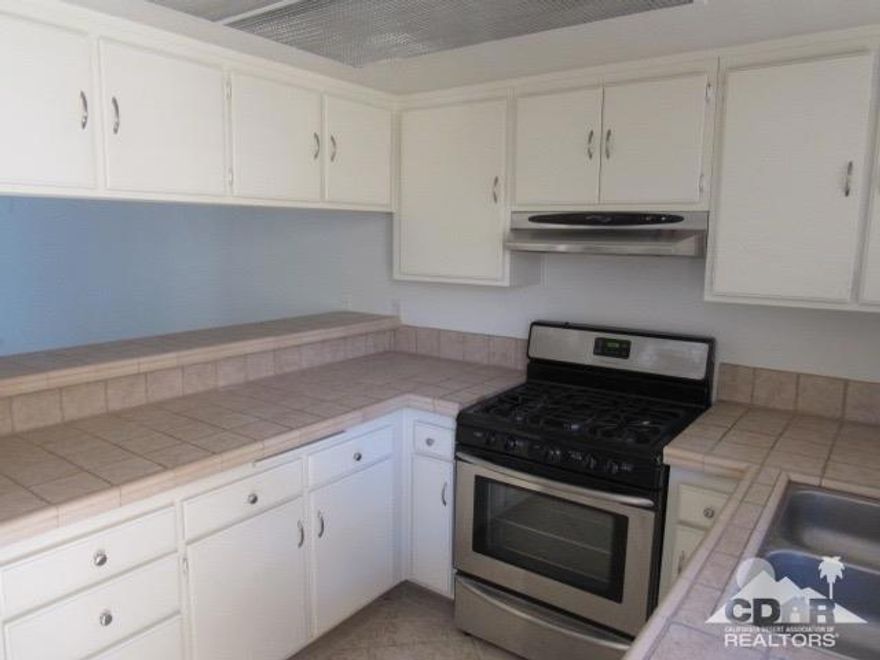 Well maintained end unit condo in Rancho Mirage. One bedroom downstairs with full bath and one bedroom upstairs with full bath. Stainless steel appliances and tiled kitchen counters. Newer Heat and A/C unit. Has balcony off upstairs bedroom overlooking tennis courts. Private covered patio between condo and garage, with built-in bar-b-que and paved flooring. Second patio in front facing tennis courts. Close to pool and the club house. Complex has recently paved the streets and upgraded to more desert landscaping. Location is close to schools, shopping and restaurants.