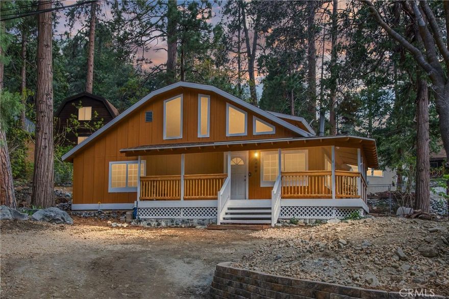 PRICE REDUCED AND READY FOR YOU TO MAKE AN OFFER! Tucked beneath the tall pines of Forest Falls, this inviting mountain retreat blends rustic charm with modern comfort. Thoughtfully restored in the 1980s, the home has recently undergone updates, offering comfort, efficiency, and timeless style. Step into the vaulted-ceiling living room, where a cozy wood stove set against a stone hearth invites you to relax after a day outdoors. The open layout flows into a spacious kitchen with updated cabinets, stainless steel appliances, and plenty of room to gather. New flooring downstairs, fresh paint throughout, and a newer mini-split system with dual compressors ensure year-round comfort. A whole-house and attic fan adds even more energy efficiency. With two main-floor bedrooms and a full bath, plus a private upstairs primary suite and loft, there’s room for family, friends, or a peaceful home office. Enjoy the sounds of nature from the covered deck—ideal for morning coffee or stargazing nights. Just a short walk to the stunning Big Falls Waterfall and scenic hiking trails. Whether you’re looking for a weekend getaway or a full-time escape, this Forest Falls cabin invites you to slow down and savor mountain living.