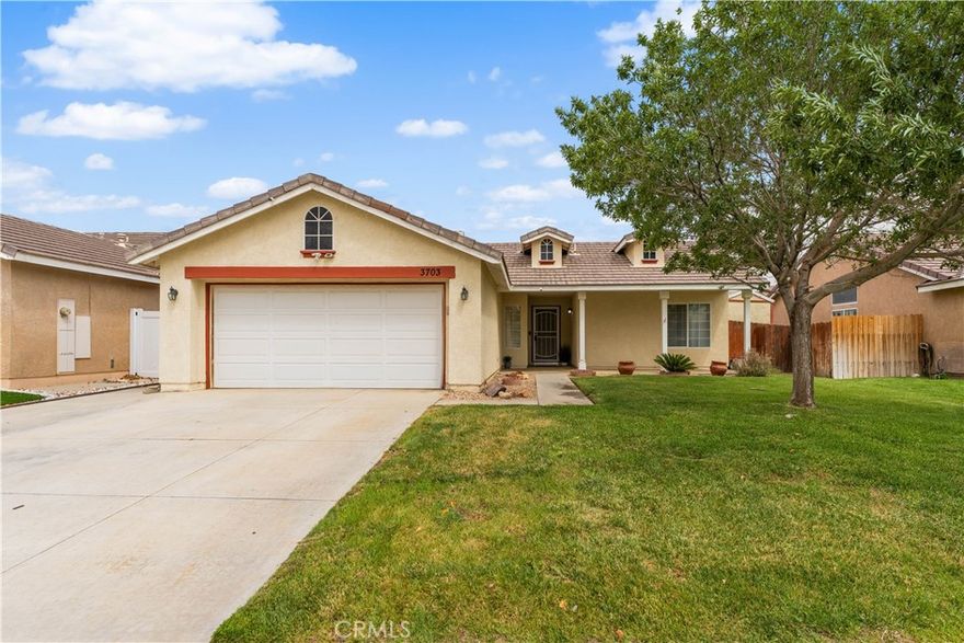 Welcome to this beautifully updated four-bedroom home that's truly move-in ready! The kitchen, refreshed just a few years ago, boasts gorgeous granite countertops and modern tile flooring—granite that also elevates the renovated primary bathroom. Elegant LVP hardwood floors, installed two years ago, run through the main living areas, creating a seamless and inviting feel. Ceiling fans throughout the home add year-round comfort. This home has been thoughtfully maintained for peace of mind: a newer A/C compressor, backyard irrigation system, and water isolation tank are already in place. The bedrooms were repainted a couple of years ago, and the kitchen sink is equipped with both a water softener and filtration system. Recently painted eaves further enhance the home's curb appeal. Step outside to a covered patio, the perfect setting for barbecues or simply relaxing with friends and family. To top it all off, the home includes a transferable two-year home warranty with added A/C coverage.