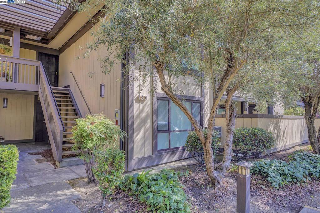 Beautifully updated upper-level 2-bedroom, 2-bath condo in one of Fremont’s most desirable gated communities—The Vineyards. This top-floor model unit features soaring ceilings, wood-beam accents, and abundant natural light from a skylight. The open living area includes laminate flooring, a cozy fireplace, and a spacious private balcony with storage. The remodeled kitchen offers newer cabinets, granite countertops, and a modern sink. Additional highlights include an in-unit washer and dryer and a wall A/C unit in the living room. Community amenities include a pool, spa, and gated security. Conveniently located across from Fremont Hub with Target, Trader Joe’s, Marshalls, and dining options, and just minutes from Lake Elizabeth, BART, I-880, Kaiser, and the library. Move-in ready and full of charm—don’t miss it.