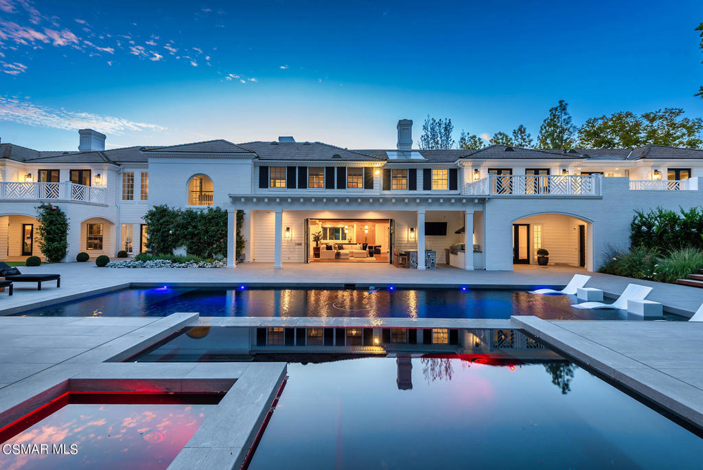 Iconic Landmark estate ideally set on 2.31 private acres in guard gated North Ranch Country Club Estates! Completely Re-imagined contemporary colonial professionally designed using the very finest finishes. Spanning 12,684 square feet, this masterpiece estate boasts 5 bedrooms, 9.5 baths, theater/game room, 2 offices, bonus room and a magazine quality center island kitchen which opens seamlessly into the family room. The primary suite is graced with two magnificent bathrooms that connect at a oversized steam shower. There is also two large walk in closets, fireplace and a balcony. upstairs, there are three additional en-suite bedrooms. The newly rebuilt backyard is second to none! there is a custom pool and spa, separate in ground cold plunge pool, one of a kind extensive firepit with bubbling water feature, pool house with gym and bathroom, covered outdoor living room, pickleball court with lights, planters, fruit trees and massive manicured lawns all with total complete privacy! other amenities include a very special 7 car garage, large motor court, all new professional landscape, drought tolerant turf, smart home technology, Lutron lighting, cameras with elaborate high tech security system, generator and golf course views. A very special offering in one of southern California's premier guard gated golf course communities.