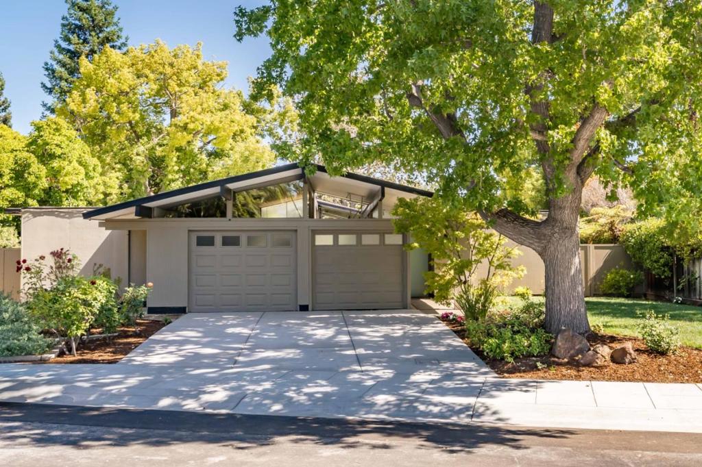 Bright and fresh, this classic Eichler sits on a tree-lined street and showcases the timeless design elements that define the genre. Signature features are everywhere, from the welcoming open-air atrium that offers a versatile space to relax or entertain to interior details like paneled ceilings, radiant heated floors, globe light fixtures, and expansive walls of glass that create a warm, inviting feel rooted in mid-century style. The open floorplan features a living room with fireplace, a dining area, and a chef-worthy kitchen with high-end appliances from Wolf, Sub-Zero, and Fisher & Paykel. Four bedrooms include a spacious primary suite, the backyard provides a tranquil setting ideal for outdoor enjoyment, and the carpeted garage adds flexible space for a gym or home office. Conveniently located near parks, Midtown shopping, Caltrain, and 101, this home is also served by acclaimed schools including Palo Verde Elementary, JLS Middle, and Gunn High (buyer to verify eligibility).