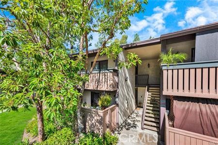 Charming and well-maintained upper-level 2-bedroom, 2-bathroom condo in the tranquil Pheasant Creek Community. This inviting living area features vaulted ceilings, tile flooring throughout, ceiling fans, recessed lighting, and direct access to a private balcony with a washer and dryer room, creating a bright and airy living space. The spacious primary suite includes two large closets, while the secondary bedroom also offers generous storage. The updated kitchen is appointed with granite countertops, recessed lighting, and tile flooring. This Condo has assigned one carport and one open space. Community amenities include multiple pools and spas, a picnic area, tennis and sports courts, and access to nearby walking and hiking trails. HOA dues cover water, trash, and exterior maintenance. Ideally located close to Saddleback Church, shopping center, parks, schools, and major commuter routes.