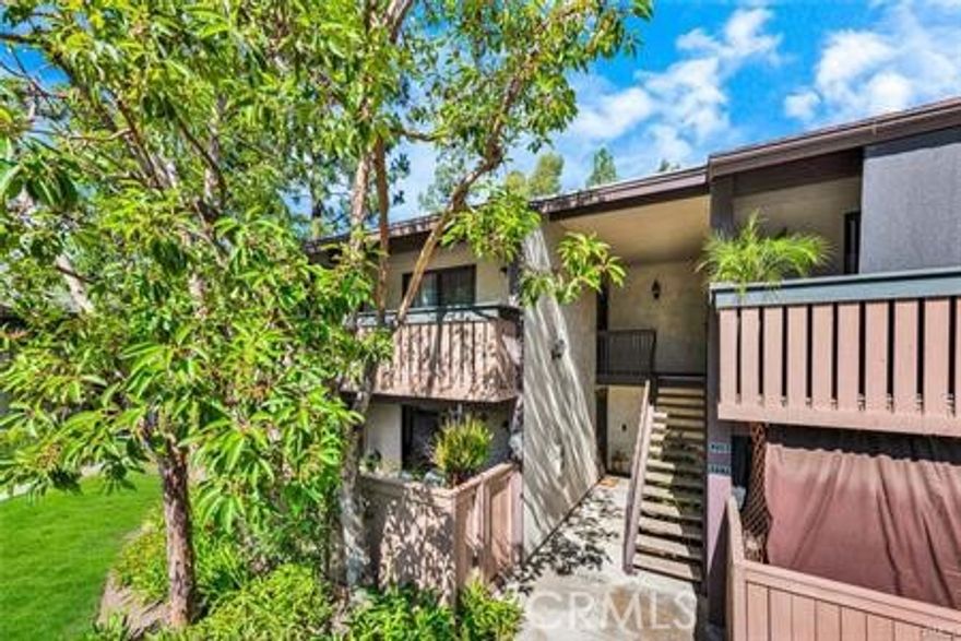 Charming and well-maintained upper-level 2-bedroom, 2-bathroom condo in the tranquil Pheasant Creek Community. This inviting living area features vaulted ceilings, tile flooring throughout, ceiling fans, recessed lighting, and direct access to a private balcony with a washer and dryer room, creating a bright and airy living space. The spacious primary suite includes two large closets, while the secondary bedroom also offers generous storage. The updated kitchen is appointed with granite countertops, recessed lighting, and tile flooring. This Condo has assigned one carport and one open space.  Community amenities include multiple pools and spas, a picnic area, tennis and sports courts, and access to nearby walking and hiking trails. HOA dues cover water, trash, and exterior maintenance. Ideally located close to Saddleback Church, shopping center, parks, schools, and major commuter routes.