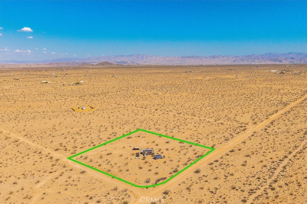 Unique opportunity to own a 2-acre lot in Joshua Tree featuring a 1-bedroom off-grid tiny home with solar power, an outdoor bathroom, 20' storage container, and a 2,500-gallon water tank. Peaceful desert views and endless potential.