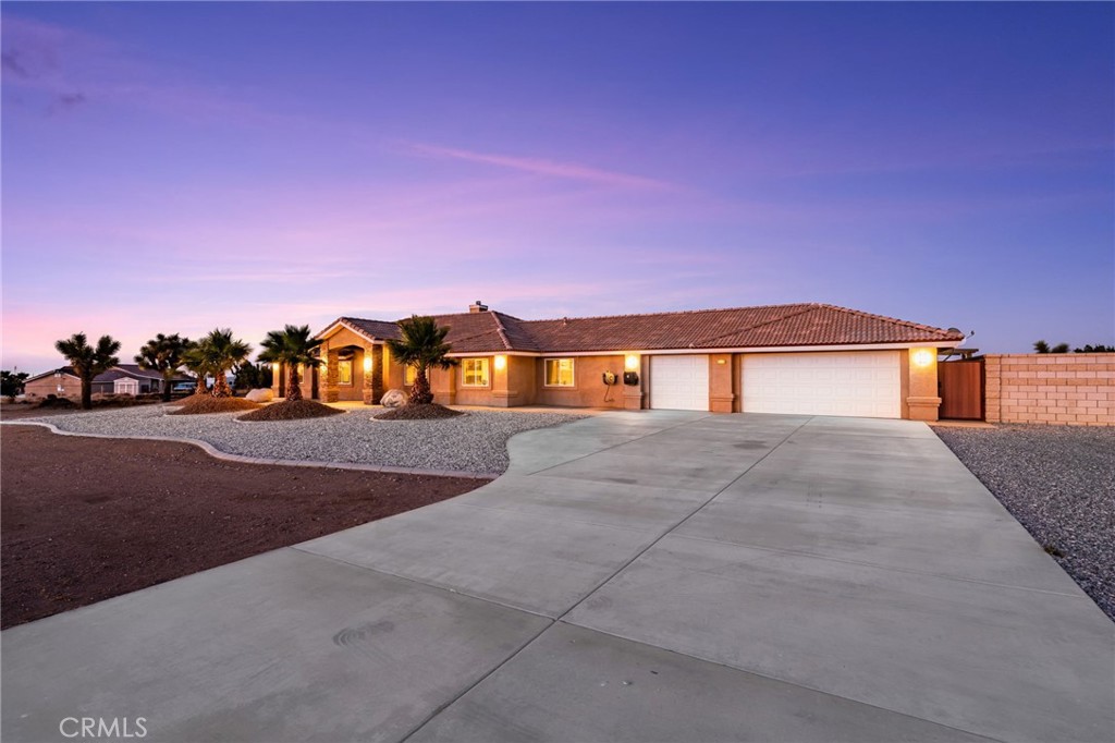 Welcome to your Desert Dream! This OAK HILLS, POOL HOME is situtated on nearly 2 acres, located on a paved road, connected to natural gas, and within the snowline school district. This home offers 4 bedrooms, 3 bathrooms, and boast of a split floor plan offering an in-law sute, providing privacy and comfort for your guest. With no details spared on this home, the property comes fully fenced with 2 separtate access gates, a block wall for additonal priavcy around your pool and backyard patio area, stucco in fascia/eaves and pre wired for surveillance system. At the front door entrance you will be greeted by a modern storm door-providing extra security. Inside features include brand new interior paint throughout with custom hardware and doors, newly painted kitchen and hallway cabinets with new hardware, new premium carpet and padding, new 17 seer air conditioner with new R454B refrigerant. Other features inlclude wood-like tile that runs throughout all the main living areas. A fireplace stacked in stone that has a wood burning insert. Your Kitchen will offer you a modern open concept with quartz countertops, above the range pot filler, stainless steel appliances, soft close cabinets, and bar stool seating. As you step into your backyard enjoy outdoor living with your saltwater pool, and spa which are both bluetooth controlled for convienience. In addition this backyard THREE seperate alumawood patio covers, and a gas firepit to enjoy around the pool. The grounds are landscaped with brand new artifical turf, decomposed granite, palm trees, and fenced in garden. You will find great stoarge between the 3 car gaarge, outdoor storgae sheds, cement-mounted racks built to store heavy duty materials, and tons of space for your RV, toys, and Tractors. The three cara garage offers additional Parking, with two-220V outlets (30amp option for EV charging and 50amp for high powered equiptment). You will be located in close distance to shopping centers and only 5 minutes from the 15 freeway, this homes offers the perfect balance of rural and city living with great accessiblity.