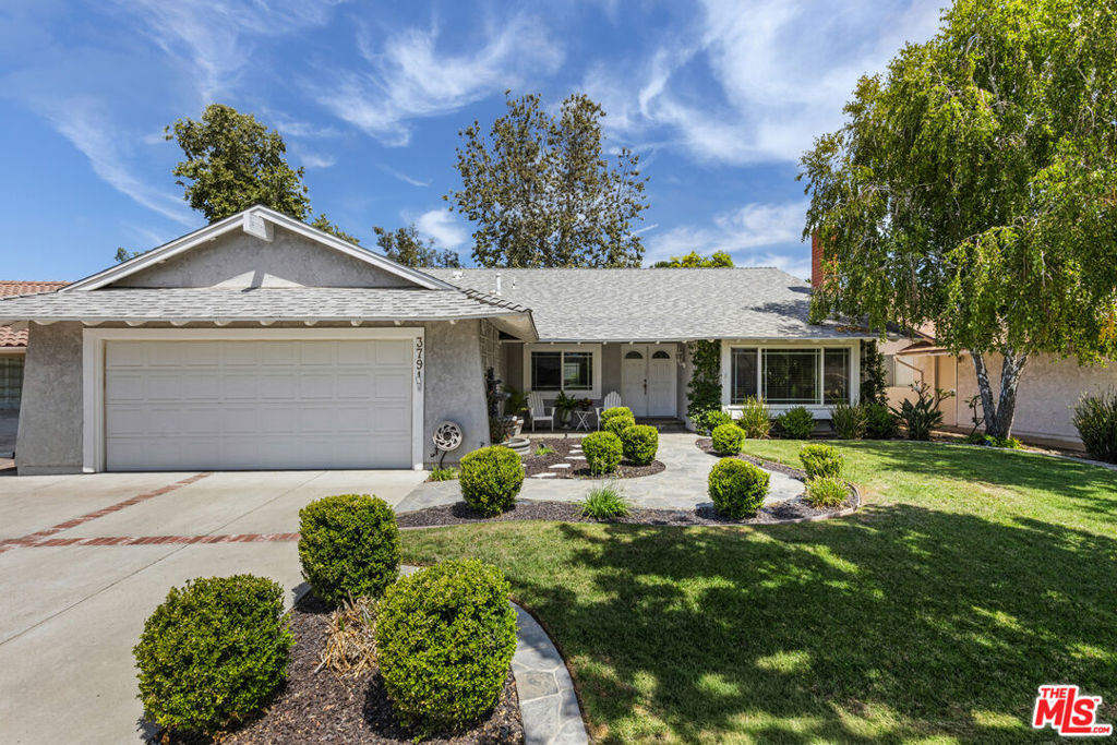 Located in the heart of Simi Valley on a peaceful street, this beautifully maintained single-story traditional home offers nearly 2,000 sq ft of living space with 4 bedrooms and 2 bathrooms. One of the most desirable floor plans in the New Monterey tract, the residence features a bright living room with vaulted ceilings and a cozy fireplace, a spacious dining area, and a large custom kitchen with abundant cabinetry, generous counter space, island ideal for entertaining. The adjoining family room with built-in shelving opens through sliding glass doors to a private backyard oasis with a covered patio, pool, and spa. The primary suite enjoys vaulted ceilings, direct patio access, and an en-suite bath with dual vanities and a walk-in shower, while three additional bedrooms provide flexibility for guests, work, or play, complemented by a modern second bathroom. Additional highlights include a direct-access two-car garage, large utility room, ample storage, laminate wood floors, tankless water heater, automatic sprinklers, and ceiling fans throughout, all just minutes from Civic Center Plaza, the Simi Valley Farmers Market, and convenient access to the 118 freeway.