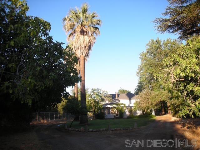 Don't miss out on this opportunity to see this three-bedroom house, with 11 ft ceilings with exposed redwood beams, rock fireplace with hardwood floors in the large living room. Dining room with picture windows facing mountain views, and a galley kitchen. Windows were all retrofitted to dual pane windows. There are two enclosed porches, and beautiful pool for great fun and entertainment.