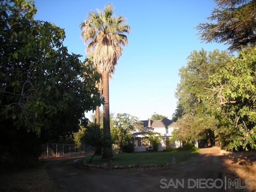 Don't miss out on this opportunity to see this three-bedroom house, with 11 ft ceilings with exposed redwood beams, rock fireplace with hardwood floors in the large living room.  Dining room with picture windows facing mountain views, and a galley kitchen. Windows were all retrofitted to dual pane windows.  There are two enclosed porches, and beautiful pool for great fun and entertainment.