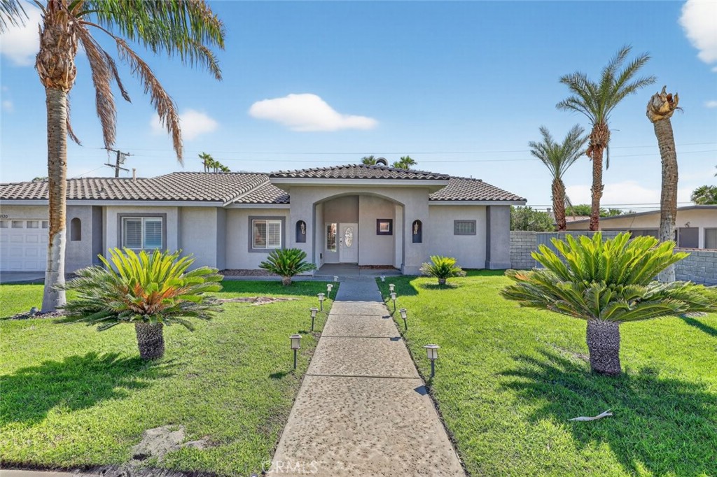 Welcome to your dream retreat in the heart of Palm Springs! This beautifully styled 4-bedroom, 2.5-bath estate blends resort-style luxury with everyday comfort and it is fully equipped for both relaxation and entertaining. Inside, enjoy an open, airy layout with high ceilings, recessed lighting, and abundant natural light. The chef's kitchen includes all essential appliances, a kitchen island with breakfast bar, and a formal dining room, perfect for casual meals or hosting dinner parties. The spacious living room features a cozy fireplace, adding warmth and ambiance. The primary suite is a true retreat with its own fireplace, while three additional bedrooms offer flexibility for guests, family, or a home office. You will also find a dedicated indoor laundry room, a generous garage, and ample driveway space with room to park a boat or RV.
Enter into an entertainer's backyard that has it all: a built-in BBQ, covered seating areas, a covered outdoor pool table, and even your own golf course setup. Take a dip in the heated pool or soak in the infinity edge Jacuzzi, then unwind around the fire pit under the desert sky. Fully paid-off solar panels provide low energy costs and sustainable power, perfectly suited for desert living. Whether you are entertaining guests or enjoying peaceful evenings at home, this Palm Springs oasis has everything you need. Welcome home!