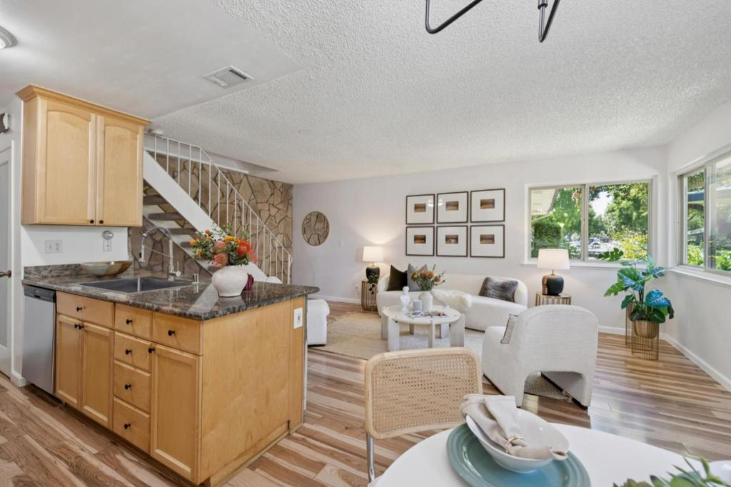 Just a few blocks to vibrant Downtown Campbell, this charming condo is tucked away in the highly sought-after Hamilton Downs community. Located on a quiet, tree-lined street, the 2-bedroom, 1-bath home offers 903 sq ft of thoughtfully designed living space in a warm, welcoming two-story layout. The open-concept design features an updated kitchen with stainless steel appliances, granite countertops and attractive cabinetry perfect for hosting and enjoying time with family and friends. The spacious primary bedroom includes room for a desk or workspaceideal for working from home. Fresh paint, brand new carpet, dual-pane windows, central heating and A/C provide year-round comfort. Fantastic for first-time buyers or investors, this move-in-ready unit includes a covered carport with private storage. Enjoy easy access to The Pruneyard, Los Gatos Creek Trail, Campbell Library and the popular Sunday Farmers Market. Convenient to Hwy 17, 280, 85 and San Tomas Expressway, along with major tech employers Apple, Google, Nvidia, Adobe and many more. A wonderful opportunity to experience urban living with a peaceful neighborhood appeal in such a prime location!