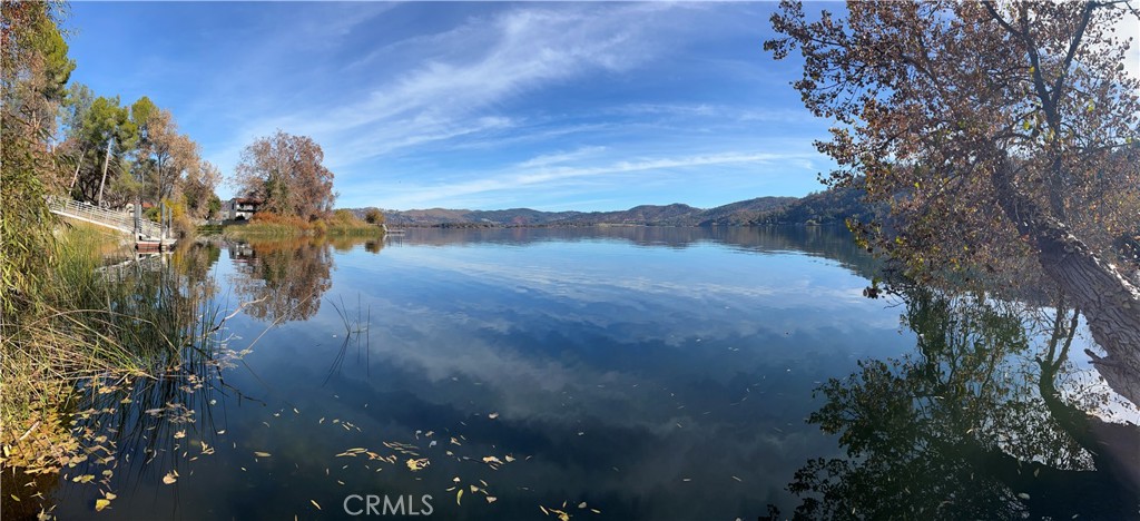 LAKEFRONT PARCEL WITH BOAT SLIP AND SEPTIC Almost an acre with 107 ft of lakefront out on the point in Clearlake Park. Level area to build beside the lake with additional building possibilities higher up on the parcel with panoramic lakeviews. Additional nearby shared boat ramp with full drive down access and storage locker. Seclusion and privacy are yours here with easy lake access to get out on the water for fishing and other recreational possibilities.