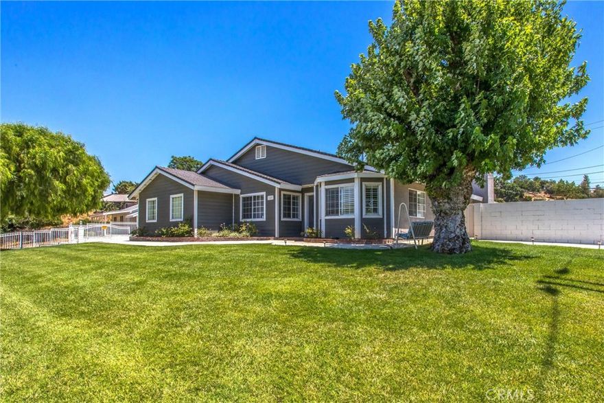 Incredibly rare opportunity in highly desirable South Redlands—TWO large, fully detached homes on a spacious half-acre lot with water shares, centered around a stunning resort-style pool and spa. Located in the highly sought after, Mariposa Elementary School boundary, this one-of-a-kind property offers versatility for multi-generational living, investment income, or a vacation rental setup (currently used as a high-performing short-term rental with positive cash flow)! The main house, built in the late 1990s, features new HVAC (June 2025), whole house generator, whole house fan, 4 spacious bedrooms, luxury-remodeled bathrooms, and an open layout with high-end finishes. The gourmet kitchen includes dual ovens, abundant counter space, bar seating, and all appliances stay. The primary suite offers a beautifully finished bathroom and an oversized walk-in closet. Additional highlights include an indoor laundry room, built-in entertainment cabinetry in the family room, and an oversized 2-car attached garage. Step outside to your private oasis: a sophisticated sparkling pool and spa, controlled by an advanced smart pool system (automated refill, lighting, heating, and vacuuming—all app-managed), with two jet-style waterfalls and a built-in BBQ area. The grounds are meticulously landscaped with lush greenery, maintained via a drip irrigation system, and designed to host unforgettable gatherings in a peaceful, nature-inspired setting. The back house, built in the mid-1960s, is equally updated with newer HVAC (approx 2 years old), 3 bedrooms and 3 bathrooms. The oversized primary suite features a remodeled bathroom (July 2025) and large closet. The remodeled kitchen (also July 2025) is modern and functional. The layout includes a family room off the kitchen and a huge bonus room, ideal for expansion, recreation, or additional living space. Indoor laundry included.  Additional highlights include a gated driveway with parking for multiple vehicles, a 100+ ft RV area with water, electric, and dump station hookups, and a 60-panel (40 on the main house and 20 on the back house) paid-off solar system with a newer inverter (recent utility costs around $200/month for both homes during summer months). Both homes and fencing were recently painted, and the entire property is beautifully maintained inside and out.  This is a one-of-a-kind property offering flexibility, space, and luxury—all in a prime location!