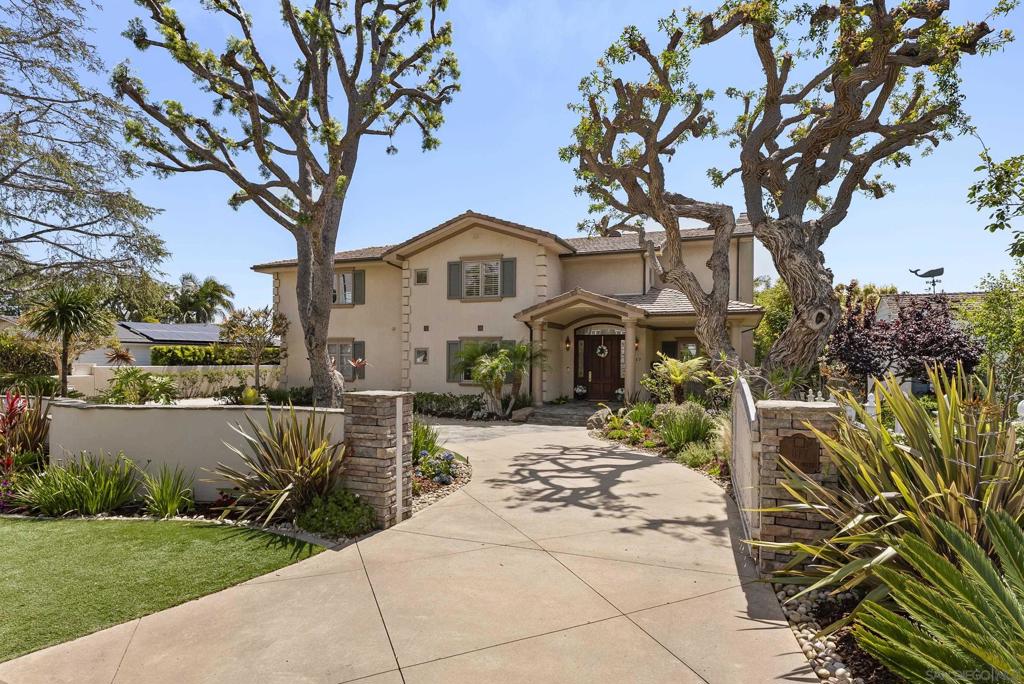 Welcome to 617 Gage Drive, a rare offering in the prestigious La Playa and Wooded Area of Point Loma. This stunning 4-bedroom, 4.5-bath home with a detached guest house sits on an expansive ½-acre lot and showcases uninterrupted south-facing views of Coronado, San Diego Bay, and the downtown skyline from nearly every room. Each generously sized bedroom includes an en-suite bathroom and walk-in closet, offering luxury and privacy for residents and guests alike. Inside, you'll find a warm, inviting design with original hardwood floors, a modern chef’s kitchen with stainless steel appliances and custom finishes, and an open-concept living space filled with natural light. The layout seamlessly connects to two second-floor balconies, offering even more opportunities to enjoy the extraordinary views. Step outside into your own resort-style backyard oasis, complete with a sparkling pool and waterfall, spa, outdoor fireplace, basketball court, putting green, and multiple lounge and dining areas—perfect for entertaining or relaxing in the Southern California sun. The home also features solar panels, a Tesla charger, and a 3-car garage for added convenience. Tucked away on a quiet, tree-lined street yet just minutes from Liberty Station, Sunset Cliffs, the bay, and top-rated schools, this home blends timeless charm with modern amenities. With a protected view corridor and premier location, 617 Gage Drive is an opportunity to own a truly exceptional piece of coastal San Diego real estate. Live the La Playa lifestyle—elegant, private, and effortlessly coastal.