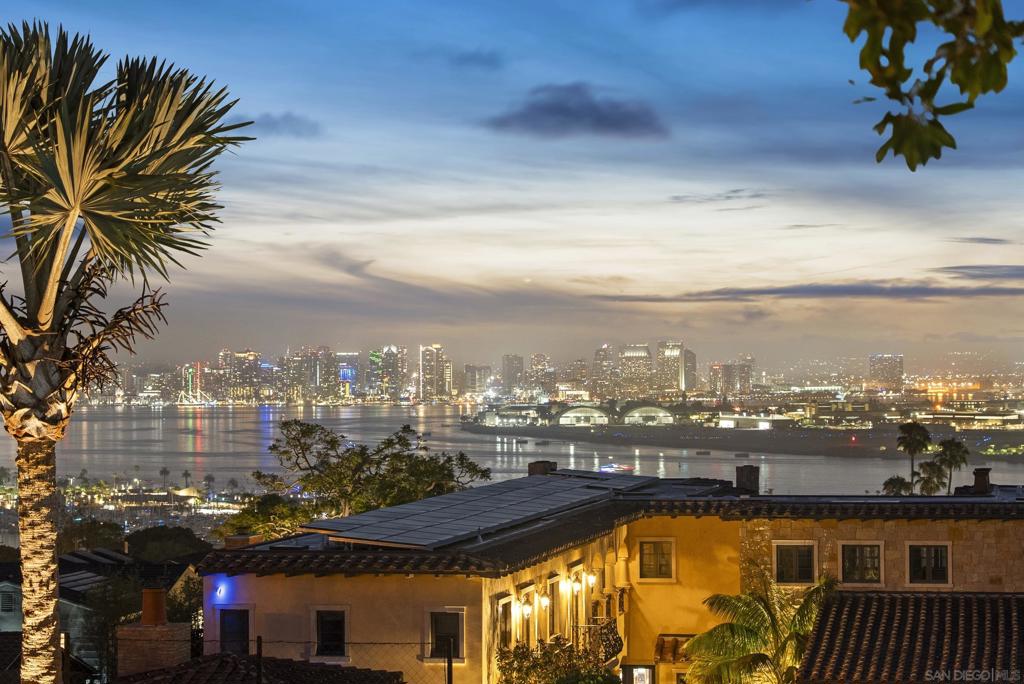 Welcome to 617 Gage Drive, a rare offering in the prestigious La Playa and Wooded Area of Point Loma. This stunning 4-bedroom, 4.5-bath home with a detached guest house sits on an expansive ½-acre lot and showcases uninterrupted south-facing views of Coronado, San Diego Bay, and the downtown skyline from nearly every room. Each generously sized bedroom includes an en-suite bathroom and walk-in closet, offering luxury and privacy for residents and guests alike. Inside, you'll find a warm, inviting design with original hardwood floors, a modern chef’s kitchen with stainless steel appliances and custom finishes, and an open-concept living space filled with natural light. The layout seamlessly connects to two second-floor balconies, offering even more opportunities to enjoy the extraordinary views. Step outside into your own resort-style backyard oasis, complete with a sparkling pool and waterfall, spa, outdoor fireplace, basketball court, putting green, and multiple lounge and dining areas—perfect for entertaining or relaxing in the Southern California sun. The home also features solar panels, a Tesla charger, and a 3-car garage for added convenience. Tucked away on a quiet, tree-lined street yet just minutes from Liberty Station, Sunset Cliffs, the bay, and top-rated schools, this home blends timeless charm with modern amenities. With a protected view corridor and premier location, 617 Gage Drive is an opportunity to own a truly exceptional piece of coastal San Diego real estate. Live the La Playa lifestyle—elegant, private, and effortlessly coastal.