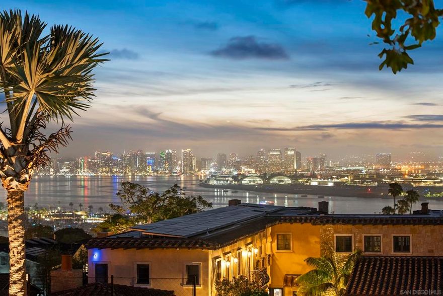 Welcome to 617 Gage Drive, a rare offering in the prestigious La Playa and Wooded Area of Point Loma. This stunning 4-bedroom, 4.5-bath home with a detached guest house sits on an expansive ½-acre lot and showcases uninterrupted south-facing views of Coronado, San Diego Bay, and the downtown skyline from nearly every room.  Each generously sized bedroom includes an en-suite bathroom and walk-in closet, offering luxury and privacy for residents and guests alike. Inside, you'll find a warm, inviting design with original hardwood floors, a modern chef’s kitchen with stainless steel appliances and custom finishes, and an open-concept living space filled with natural light. The layout seamlessly connects to two second-floor balconies, offering even more opportunities to enjoy the extraordinary views.  Step outside into your own resort-style backyard oasis, complete with a sparkling pool and waterfall, spa, outdoor fireplace, basketball court, putting green, and multiple lounge and dining areas—perfect for entertaining or relaxing in the Southern California sun. The home also features solar panels, a Tesla charger, and a 3-car garage for added convenience.  Tucked away on a quiet, tree-lined street yet just minutes from Liberty Station, Sunset Cliffs, the bay, and top-rated schools, this home blends timeless charm with modern amenities. With a protected view corridor and premier location, 617 Gage Drive is an opportunity to own a truly exceptional piece of coastal San Diego real estate. Live the La Playa lifestyle—elegant, private, and effortlessly coastal.