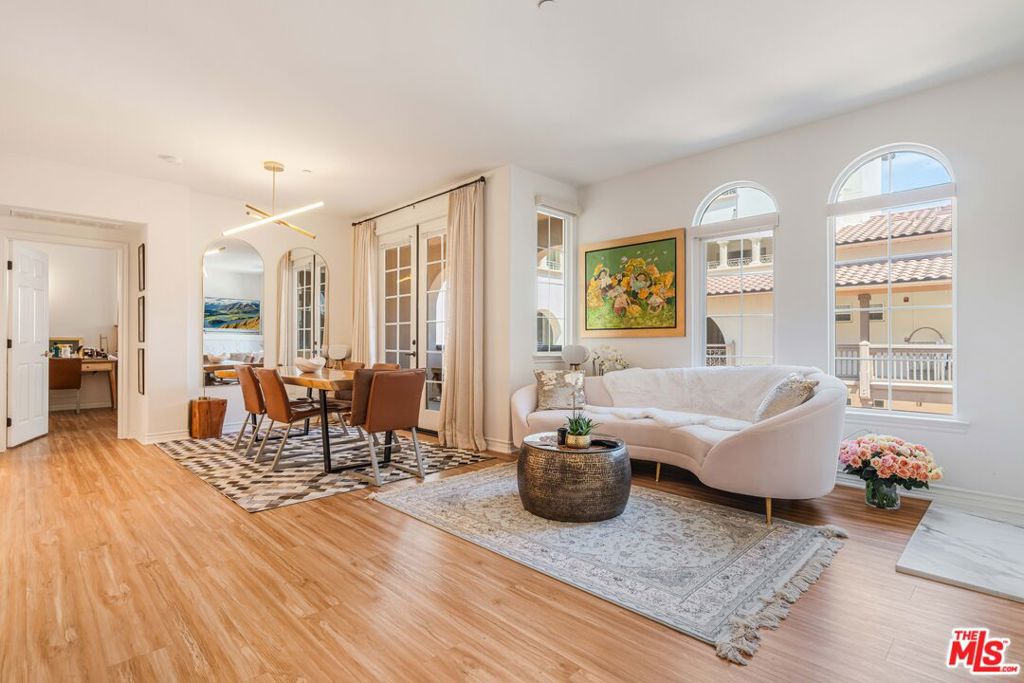 Welcome to this bright and beautifully laid-out single level home in the highly sought-after Villa d'Este community of Playa Vista. From the moment you step through the entry, you're greeted by an open and inviting floor plan that truly feels like home. This 2 bedroom, 2 bathroom home spans 1,260 square feet and offers a perfect blend of style and comfort. Sunlight pours through arched living room windows, showcasing peaceful courtyard views and filling the space with morning light. The kitchen is both functional and stylish, featuring thoughtful upgrades such as new quartz countertops, new refrigerator, oven and microwave, plus a wine fridge and a spacious peninsula that makes hosting effortless. Just off the dining area, French doors open to a large private balcony, an ideal spot for morning coffee or relaxing outside. The balcony also connects directly to the primary suite for a lovely indoor-outdoor flow. In the primary suite, you'll find a spa-like ensuite bathroom complete with upgraded countertops, modern fixtures, a frameless glass shower door, dual sinks, a soaking tub, and a separate walk-in shower. The secondary bathroom has also been beautifully updated with new countertops, a sleek new faucet, and a frameless shower door, providing a cohesive and elevated design throughout the home. The secondary bedroom is thoughtfully positioned on the opposite side of the home, offering privacy and a sense of calm. It's perfect for guests, a home office, or both. A custom built-in Murphy bed in the living adds versatility and provides an additional space for guests. Motorized blinds provide convenience to easily create even more privacy. With just 39 residences, Villa d'Este offers a boutique feel and lush surroundings, including three beautifully landscaped courtyards. This home is ideally located across from the Playa Vista CenterPointe Club and library, and just blocks from Playa Vista Elementary. Additional features include side-by-side parking with an EV charger and private storage in the subterranean garage, plus access to top-tier amenities like The Resort Health Club and CenterPointe Club. All this is just moments from the best of Playa Vista, including Whole Foods, Hopdoddy, the Cinemark theater, and more. This is your opportunity to live in one of Silicon Beach's most vibrant and connected communities!