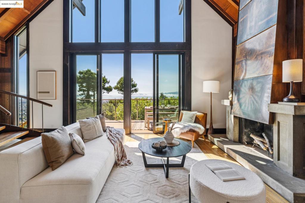 Panoramic views and dramatic 4BR/3BA custom home on a private oversized lot with breathtaking views from nearly every room from this unique property. Soaring vaulted living/dining room with copper-clad fireplace opens to floor-to-ceiling windows and a huge view deck. Level-in bedroom suite with full bath. Remodeled sun-filled kitchen with new cabinetry, appliances, and ample storage. Sculptural open staircase leads to a stunning upper-level suite with soaring ceilings, windows on two sides, generous closet space, and a newly remodeled spa-inspired bath with a double vanity. Lower level includes two bedrooms, family room, and full bath. Detached 2-car garage + parking for 5. Lush downsloped mature gardens with winding paths. This stunning oasis is located in Berkeley’s historic Panoramic Hill neighborhood above UC Berkeley - just moments to campus, hiking trails, and downtown. Views: Downtown
