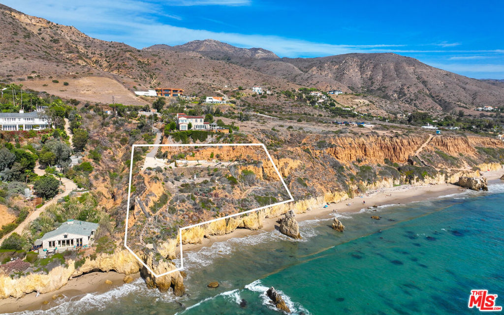 Perched on a scenic bluff above El Matador Beach, this stunning parcel of more than 2.2 acres is complete with Building & Safety approved house plans for a near-replica of the property's memorable and majestic stone house.With approximately 266 feet of frontage, beach access, and sublime ocean, island, and coastline views, this is one of Malibu's most coveted addresses. Set behind gates at the end of a long drive, the Michael Lee design integrates architectural inspiration and fixtures imported from Buenos Aires, Majorca, and Marseille. Exposed beams, wrought iron detailing, stone-tile floors, wraparound verandahs, and views, views, views create the perfect setting for congenial indoor-outdoor gatherings both intimate and grand. On the main floor is an open, European-feel living/dining great room, a professional chef's kitchen, and two bedrooms, while the entire upper level is home to the romantic and much-expanded primary suite, with fireplace, spa-style bath, and enormous, private, ocean-view verandah. Inspired landscaping and El Matador's picturesque sea stacks complete this distinguished estate property. The plans call for added storage space on the basement level; the design for a new retaining wall has been submitted for City approval. A singular location for a residence and lifestyle of substance and sophistication.