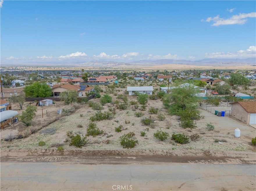 Ideally located just minutes from the entrance to Joshua Tree National Park and the 29 Palms Marine Base, this property offers an opportunity to create your own desert retreat in the heart of Twentynine Palms. The land is accessible on the last paved road in the Hanson tract with water and electric utilities nearby. Enjoy unobstructed views of the National Park to the south and quick access to the Utah Trail entrance. Whether it’s hiking, climbing, catching spectacular sunrises and vibrant sunsets, stargazing, or simply soaking in the peaceful Mojave Desert landscape, you’ll have it all at your doorstep. This lot is perfect for building a primary residence, a vacation getaway, or an investment property. More than just land, it’s a lifestyle shaped by natural beauty, quiet seclusion, and endless possibilities. Don’t miss your chance to own a parcel ready for your vision and waiting to become your desert escape.
