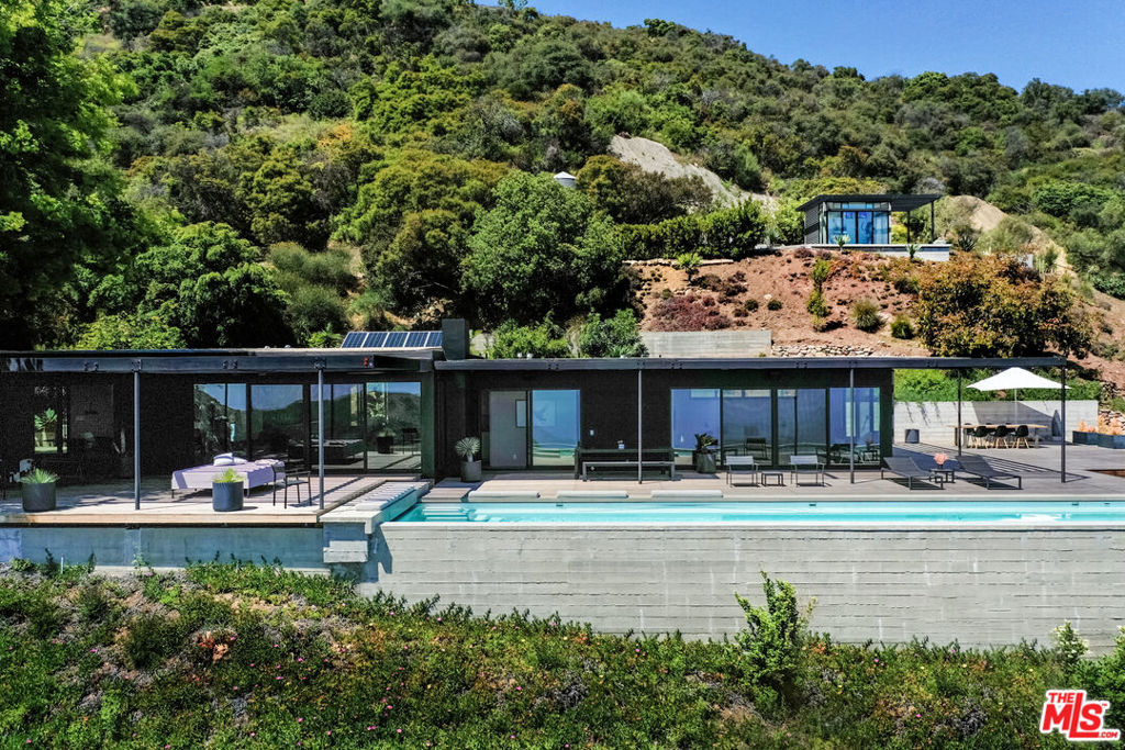 Truly one of a kind stunner designed by Vitus Matare & Associates. This Masterpiece sits on approx. 8 acres of extensive gardens and landscape incorporating boulders, a waterfall feature, and serenity galore. The 2 bed, 2 bath main house is exquisite down to the tiniest detail including Boffi kitchen, Miele appliances, Lindner floor heating, Smart Home, Sonos, and so much more. Detached structures including guest house, office, beautiful garage & carport, and an additional out building throughout the grounds help to create a most epic and unique property experience. Panoramic Queen's Necklace and ocean views including Palos Verde, Catalina, Channel Islands and beyond complete this picturesque gem. Sold before processing, entered solely for comp purposes.