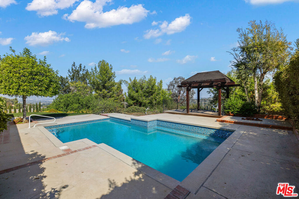 Stunning and Sophisticated Midcentury pool home with amazing 200+ degree views situated on sprawling grounds in verdant hillside setting. Completely remodeled by owner for owner. The home has the luxurious interior polish of a modern home. The turnkey 4 bedroom 3 bath residence with private, fenced yard is graced by a magical pastoral surround and stunning valley and mountain views. Features include a cook's kitchen with brand new appliances, Dolby surround system, vaulted ceilings, and impeccable style. The open plan public rooms and the spacious primary suite have jetliner views and play to the resort-like backyard creating a smooth transition between indoor and outdoor living. Replete with remodeled, heated pool with pebble and glass tile, deck and trellis, expansive flat grass, turf area and breathtaking views. The space is ideal for recreation or relaxation. Attention to detail, and idyllic surround set this home apart. This turnkey showcase is one of a kind in a private setting south of the boulevard.