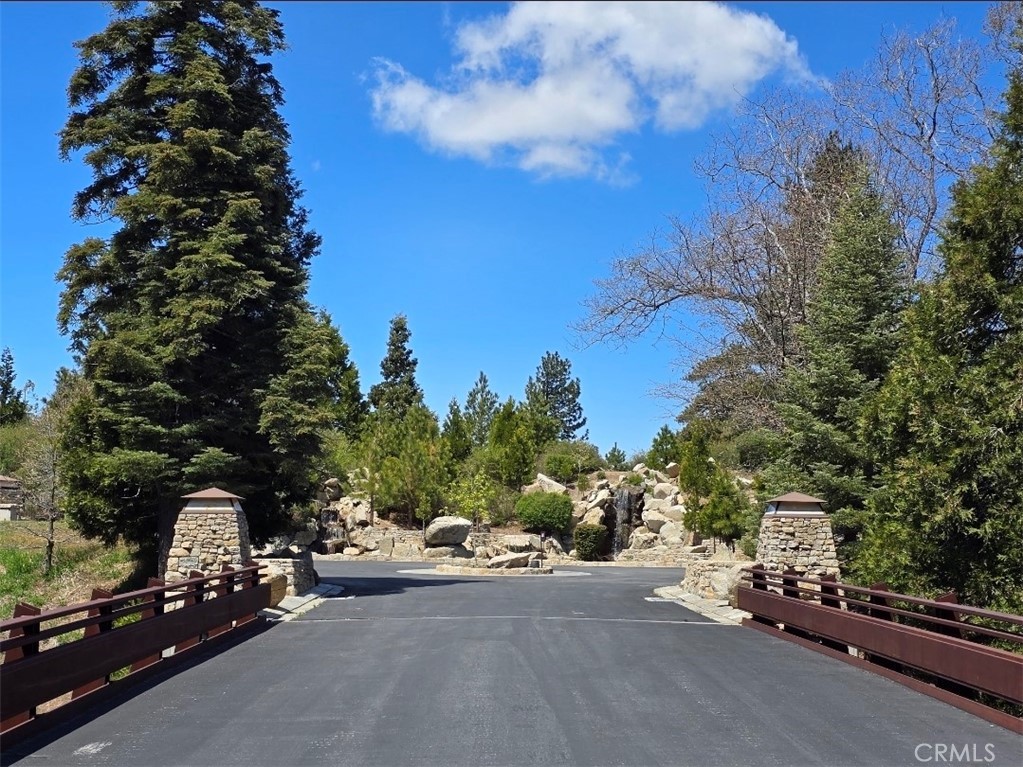 Build Your Dream Home with Sweeping Lake Views in Prestigious Mill Pond at Lake Arrowhead:
Here’s your chance to claim one of the most desirable pieces of land in Lake Arrowhead’s exclusive Mill Pond community—a private, gated enclave known for its elegance, natural beauty, and unbeatable location. Just minutes from lakeside trails, the marina, and the shops and dining of Lake Arrowhead Village, this property combines the serenity of mountain living with convenient access to everything you need. Situated on a gentle downslope with clear, uninterrupted views of the lake, this lot is ready for your vision. Underground utilities—including electricity—preserve the scenery, while wide, well-maintained roads ensure easy access year-round. With construction booming and custom homes rising throughout the community, now is the perfect time to invest. Ownership includes full lake rights, so you can start enjoying the water and the mountain lifestyle from day one.