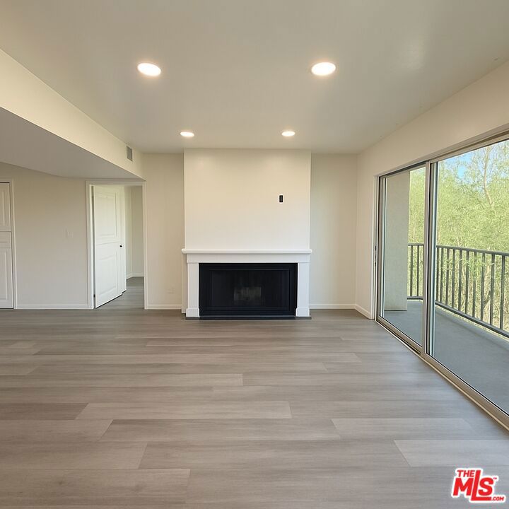 This beautifully renovated 2 bed | 2 bath condo in the heart of Sherman Oaks offers a serene retreat with an ideal split-bedroom layout for privacy and 2 parking spaces. Updates include new luxury vinyl plank floors, fresh paint throughout, new bathroom vanity mirrors, modern sliding closet doors, sleek lighting throughout, and a converted wet bar now featuring stylish storage and shelving. The bright, open-concept living space boasts recessed lighting, a cozy gas fireplace, in-unit washer & dryer, Nest system, and an expansive balcony surrounded by lush greenery. The kitchen shines with quartz countertops and new stainless steel appliances, while both spacious bedrooms enjoy ample closet space and soft natural light. The well-maintained building offers a heated pool, barbecue area, secure gated parking with two tandem spaces, and direct elevator access - all just moments from Ventura Blvd's shops and dining, Sherman Oaks Galleria, parks, and easy access to the 101 and 405 freeways. This private sanctuary delivers that perfect "home is where the heart is" feeling in the middle of it all!
