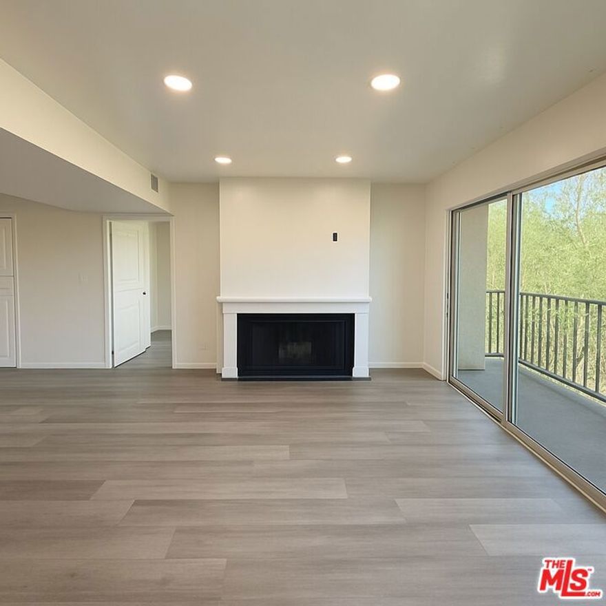 This beautifully renovated 2 bed | 2 bath condo in the heart of Sherman Oaks offers a serene retreat with an ideal split-bedroom layout for privacy and 2 parking spaces. Updates include new luxury vinyl plank floors, fresh paint throughout, new bathroom vanity mirrors, modern sliding closet doors, sleek lighting throughout, and a converted wet bar now featuring stylish storage and shelving. The bright, open-concept living space boasts recessed lighting, a cozy gas fireplace, in-unit washer & dryer, Nest system, and an expansive balcony surrounded by lush greenery. The kitchen shines with quartz countertops and new stainless steel appliances, while both spacious bedrooms enjoy ample closet space and soft natural light. The well-maintained building offers a heated pool, barbecue area, secure gated parking with two tandem spaces, and direct elevator access - all just moments from Ventura Blvd's shops and dining, Sherman Oaks Galleria, parks, and easy access to the 101 and 405 freeways. This private sanctuary delivers that perfect "home is where the heart is" feeling  in the middle of it all!