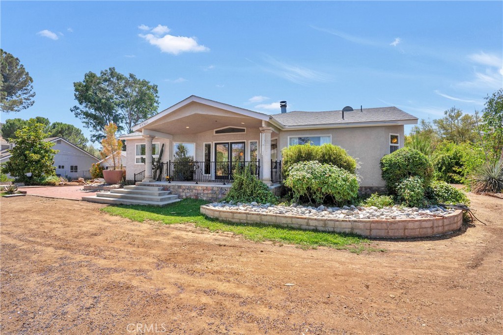 Private Equestrian Home in Menifee – 2.43 Acres of Modern Ranch Living
Welcome to your dream horse property, nestled in a secluded and serene area of Menifee. This beautifully landscaped 2.43-acre estate offers the perfect blend of modern comfort and country charm—ideal for equestrian enthusiasts seeking space, functionality, and privacy.
This 3-bedroom, 3-bath home spans 2,592 square feet and boasts an incredibly open floor plan with high ceilings, wood accents, and a spacious great room filled with natural light from large windows and glass doors. The stylish kitchen features expansive granite countertops, custom drawer-style cabinets, a breakfast bar, and beautiful lighting—perfect for entertaining and everyday living. The large utility room includes a walk-in pantry, built-in wine rack, and generous storage space. The oversized master suite is a private retreat with its own luxurious bath.
Equestrian features are thoughtfully designed:
A well-maintained barn with two horse stalls and a dedicated tack house
A spacious corral ideal for exercise and turnout
A rear-lined private driveway for easy trailer access, framed with mature Palo Verde trees and vibrant purple cactus, all on automated irrigation
Ample space to add an arena or additional stalls if desired
Room for trailer parking and hay storage
The entire property is landscaped with mature trees, flowering plants, fruit trees, and a diverse mix of desert cacti, creating a picturesque setting. Outdoor living is enhanced with an in-ground pool and spa, fire pit, and multiple lounging areas.
The attached ADU at the back of the garage includes a private entrance, kitchenette with sink and cabinets, walk-in closet, and a ¾ bath—ideal for guests, a caretaker, or rental income. Paid-for solar system offers energy efficiency and long-term savings.
Whether you're looking for a turnkey equestrian setup, a peaceful retreat, being completely off grid or a place to entertain and enjoy the outdoors, this modern ranch estate is a rare find in the heart of Menifee in the perfect location in between the 15 and 215 Freeways for easy commuting. You do not want to miss this opportunity