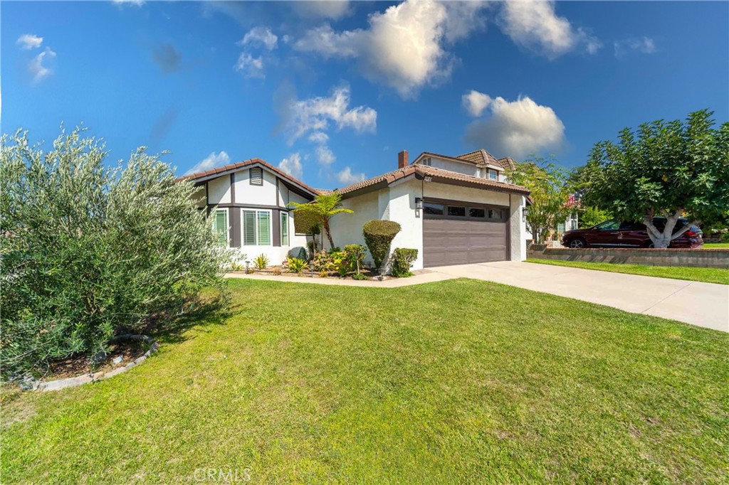Welcome to 210 S. Larkwood in the "Bel Air" neighborhood of Anaheim Hills! This stunning single-story home sits on a spacious corner lot and is move-in ready. Featuring three bedrooms and a versatile den that can serve as a 4th bedroom or office, this bright and immaculate home is filled with natural light. It has been recently updated with stylish touches like quartz countertops, recessed lighting, silhouette window treatments, plantation shutters, and fresh paint inside and out. The living and dining rooms boast cathedral ceilings and recessed lighting, while modern barn doors add charm to the den, making it perfect for a home office. The primary bedroom opens directly to the backyard, with an updated bathroom featuring double sinks and chic tile work. The secondary bathroom includes a new glass shower enclosure and sink. The kitchen is equipped with quartz countertops, a designer backsplash, white solid wood cabinetry and stainless-steel appliances. The family room highlights a designer quartz fireplace with a floating beam mantle. Both the kitchen and family room lead to a fabulous entertainer’s backyard with a beautiful paver patio and plenty of space for plants and a lawn. Conveniently located near the 241 and 91 freeways, Costco, restaurants, parks, and top-rated schools, this home truly has it all!