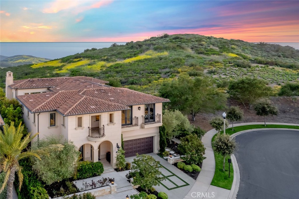 Now offering furnished or unfurnished, Love life Behind the gates of Pacific Ridge in Newport Coast. This customized FIANO residence captures unobstructed views of the Pacific Ocean, canyon, and rolling hillsides. With over 5,100 square feet of thoughtfully designed living space, the home offers 4 upstairs ensuite bedrooms, 4.5 bathrooms, and a spacious bonus room with its own balcony, ideal as a lounge, office, or media room.
The great room serves as the heart of the home, featuring soaring ceilings, abundant natural light, and seamless indoor-outdoor flow through retractable glass doors. Anchored by a sleek fireplace and open to the dining area and chef’s kitchen with a large center island and top-tier appliances, it’s a perfect space for both relaxed living and effortless entertaining.
Outside, multiple covered and open-air patios surround a private pool, offering ample space to unwind or host. The master/primary suite is a true retreat with a private balcony and a spa-inspired bath that includes ocean views, a soaking tub, walk-in shower, dual vanities, and a generous walk-in closet.
Enjoy the ultimate in coastal living, with thousands of preserved acres of hiking, biking, and riding trails literally outside of your front door leading you to Crystal Cove and beyond. Minutes from world-class beaches, top-rated schools, Pelican Hill Resort, and the shops and dining of Fashion Island. Additional community amenities include a Jr Olympic salt water pool, spa, and wading pool for the littles, all at the clubhouse at Pacific Ridge, along with multiple tot-lots, an adjacent sports park and plenty of green belts.
