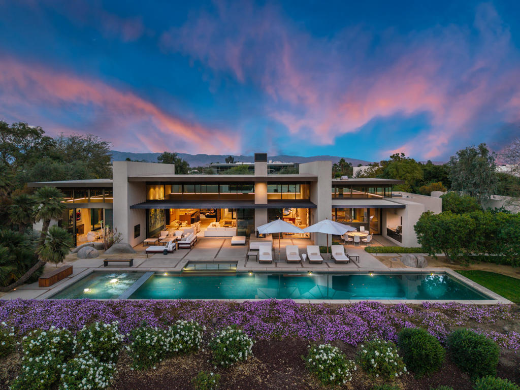 This modern masterpiece designed, by celebrated architectural Firm Marmol Radziner, offers the finest in indoor-outdoor living, seamlessly blending luxury with nature. overlooking the sixth hole of the prestigious Tom Fazio-designed golf course at The Madison Club, This 8,670 square foot home is situated on a double lot spanning over 1.76 acres on the most coveted street in the club, boasting four generously proportioned bedrooms, five luxurious full bathrooms, and an inviting half bath, all enhanced by breathtaking west facing views of the Santa Rosa Mountains. The pale palette with limestone floors, teak ceilings and floor to ceiling pocket doors create an open flow between the interior and the beautifully designed desert landscaping, every room feeling connected to the stunning natural surroundings. This home epitomizes craftsmanship, quality, design and sophistication.
