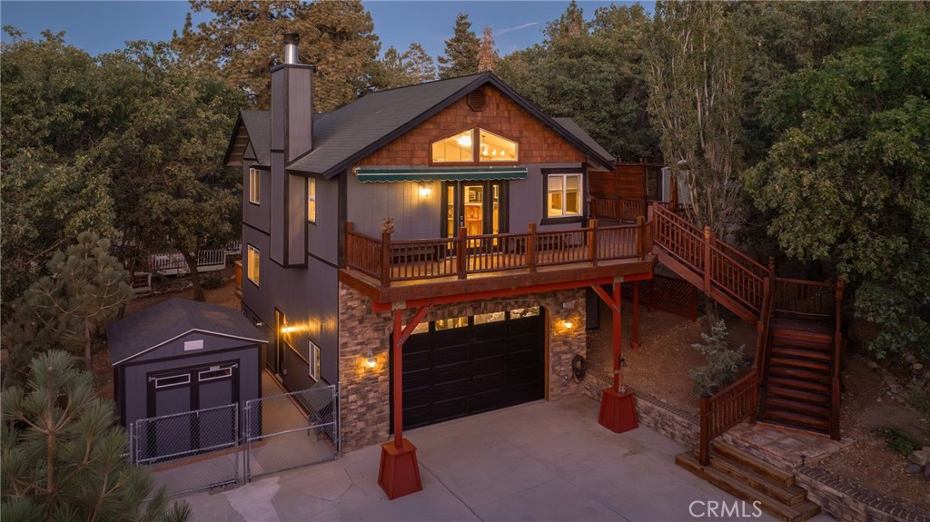 Discover serene mountain living in this beautiful, secluded custom-built home in Upper Moonridge, blending rustic charm with modern design. The inviting upstairs features a spacious master suite complete with a cozy fireplace, full bath, and a private slider opening to a deck—perfect for unwinding while enjoying stunning views. An updated laundry area, guest bedroom, and bathroom complement the open-concept living room and fully equipped kitchen, creating an ideal space for both relaxation and entertaining. Downstairs offers a third bedroom, a third bathroom, and a versatile game room with convenient access to the garage. Nestled among tall native trees on a wide, paved street with generous space between neighbors, this home also boasts a fully fenced backyard. The expansive front deck invites you to entertain guests while taking in the breathtaking surroundings. Experience privacy, comfort, and nature all in one exceptional Moonridge retreat.