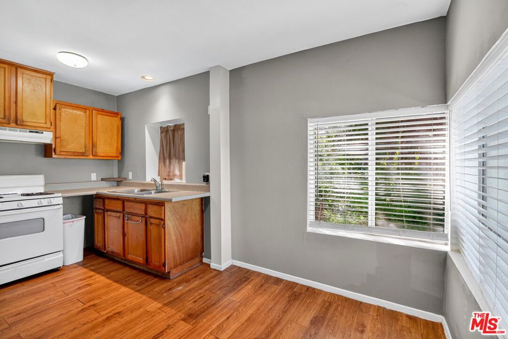 Located just off Ventura Boulevard, this 700 sq ft Studio City apartment combines hillside charm with city convenience. The open layout features wood flooring, fresh paint, a wall heater with separate AC. The kitchen offers tile counters, wood cabinetry, a gas range, and refrigerator, with room for dining or a home office. The sleeping area connects to a full bath with tub/shower, and laundry is available outside. A standout feature is the private deck, perfect for outdoor living, surrounded by mature palms and a terraced garden, with a peekaboo view that adds an extra touch of charm. Two parking spaces and close proximity to Ventura Boulevard's shops and dining complete this inviting home