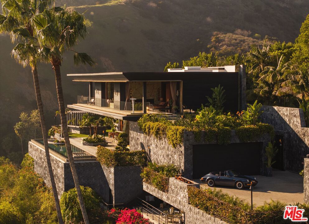Presenting the White Lotus House, an architectural modern paradise meticulously constructed over seven years, utilizing the finest materials and millions just in stonework alone. The only budget was there was no budget; everything had to be the best. Combining modern new construction with the retro charm of the golden age, embracing the rich history of Hollywood and the lifestyles of its icons. Designed with Asian influences to make you feel like you're living in paradise. Equipped with the latest amenities, and very own private speak easy night club. Situated on a promontory lot with unobstructed front row views of the city from downtown out to the Pacific Ocean. This is a one-of-a-kind trophy estate you won't find anywhere else in the world or see replicated due to soaring construction costs, architectural design significance and the attention to detail. This unparalleled estate isn't just a home; it's a once-in-a-lifetime experience for you to ink any deal and redefine the art of living.