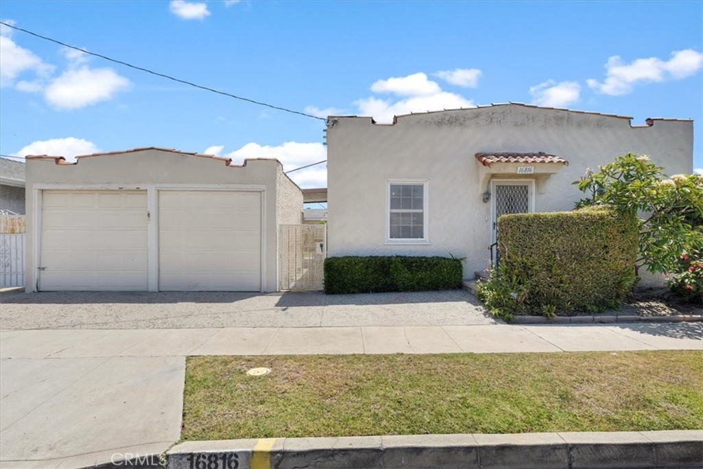 Welcome to 16816 S Harvard Blvd - a classic single-story home located in the heart of Gardena. A rare opportunity for both homebuyers and investors alike. Originally built in 1930, this home offers vintage character with a functional layout and timeless curb appeal. Step inside to the spacious living area highlighted by classic coved ceilings, which leads seamlessly into the kitchen and dining spaces. Through the hallway are the two bathrooms and three bedrooms, plus an additional room that could be used as an office/fourth bedroom. Laundry is located in the detached garage along with an additional wash sink and storage. Outside, the private backyard is a blank canvas with a covered awning and plenty of space - perfect for entertaining, relaxing, or gardening. With convenient access to the 110, 91, and 405 freeways, getting anywhere across the South Bay and Greater LA is a breeze. Located just minutes from shopping, restaurants, schools, and parks, this home combines classic charm with central convenience. Whether you're looking to move in and make it your own or explore investment potential, this home is full of possibilities.
