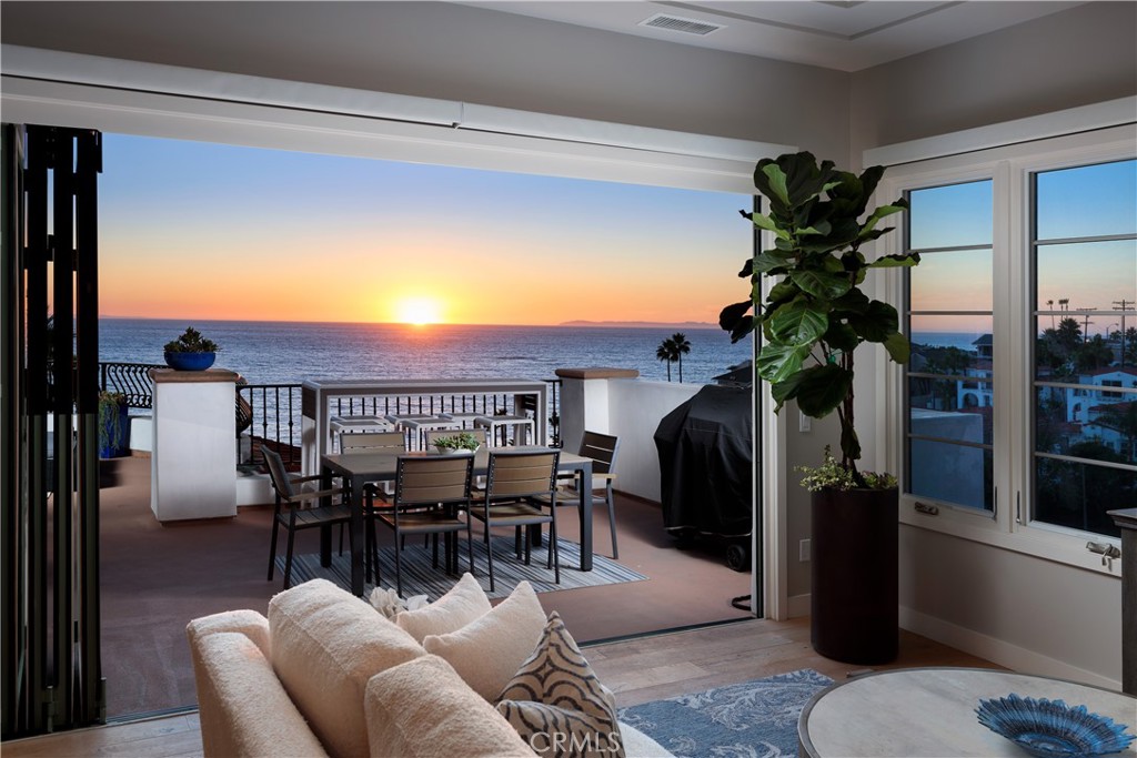THE ULTIMATE SEASIDE RETREAT with breathtaking ocean and whitewater views from this spectacular and spacious one-story "Coastal Penthouse" in prime location very near the beach, pier area, shops and restaurants of downtown San Clemente. This luxurious property boasts the finest architectural detail with an open-concept design, floor-to-ceiling windows capturing the ocean view, and large expansive deck areas, complete with outdoor fireplace, perfect for indoor/outdoor living, entertaining and relaxing while enjoying the amazing ocean view. This property spotlights an elegant use of space with large living, dining, kitchen and family room areas...all with ocean views. The Chef's kitchen is a delight with large island/breakfast bar with quartz waterfall counters and commercial style appliances. The lavish primary suite is amazing complete with a private balcony deck, ocean view, and gorgeous primary bath with dual vanity sinks and separate tub and shower. The additional two secondary bedrooms, each with ensuite bath equipped with high end designer touches, are beautifully finished. This fully furnished property, with nearly 3,000 square feet of living space plus deck areas, includes a total of 3 bedrooms, 3.5 baths and highlights the exceptional quality and ocean view from all main rooms offering a serene and secluded beachside setting. The contemporary furnishings, inside and out, are superb and designed for comfort with a casual yet sophisticated decor style. An elevator leads you to this fully furnished oasis covering the top floor plus 3 parking spaces are provided. An inside laundry room is located next to the kitchen rounding out the extraordinary amenities. Enjoy the fun and festive beach lifestyle living in this exquisite masterpiece surrounded by the tranquil sound of the rolling surf, ocean breeze, and ever-changing ocean views.
