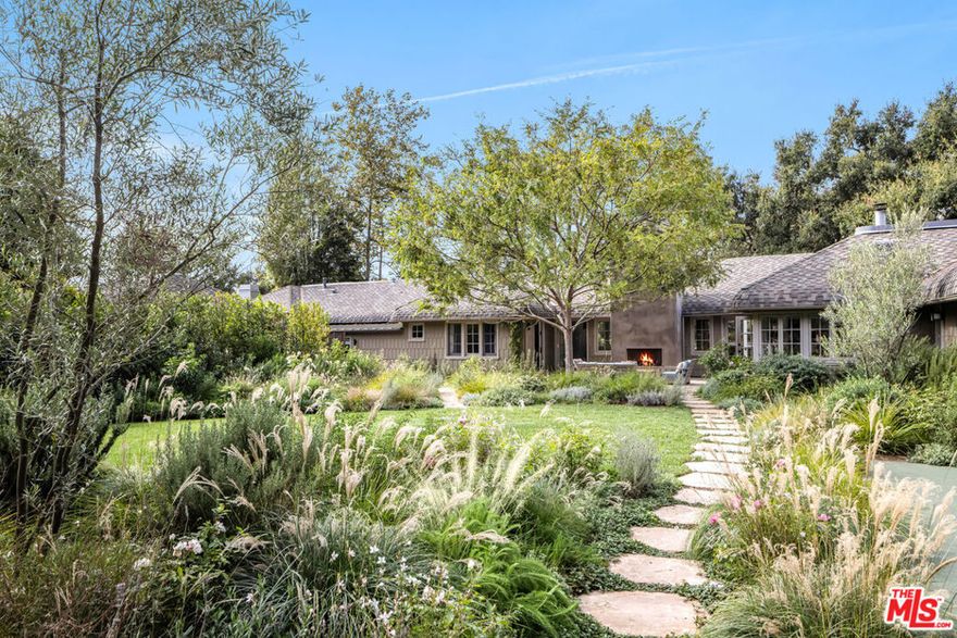 Sprawling single story California Craftsman built in 1923 on expansive, sun-filled 27,440 square foot lot in the most picturesque section of highly desirable Rustic Canyon.  Set beyond towering old growth oak trees amidst lush foliage and magical gardens, and organized around a sun-drenched courtyard with outdoor fireplace, this timeless estate offers the romance, charm and rich history of early California and The Uplifters' Ranch along with the clean, contemporary lines, sun-filled spaces and modern amenities desired for today's lifestyle.  Reimagined by much-admired and widely published Marmol Radziner architects, FAIA, the centerpiece of the home is a fabulous "great room" which consists of a cook's kitchen, family gathering & breakfast areas and opens to private, resort-like grounds with patios, sport court, field-size lawn, swimmer's pool and spa. The central living room with vaulted tray ceiling and original craftsman detailing opens to both the front and rear gardens.  There is also a cozy, inviting media room/den, large gym and two powder rooms. The family bedroom wing consists of four bedrooms and four baths, including a primary suite with dual baths. Set in the garden is a detached, self-contained two-room guest house with full kitchen and private courtyard. Other features and amenities include a bonus room that works great as a children's playroom, generous laundry room and large detached storage room. Hardwood floors, extensive built-ins and authentic craftsman touches can be seen at every turn. Gated, quiet and completely private with an out-of-Los Angeles feel, yet in close proximity to the park, recreation center and beach, this magical property represents a once in a generation offering!