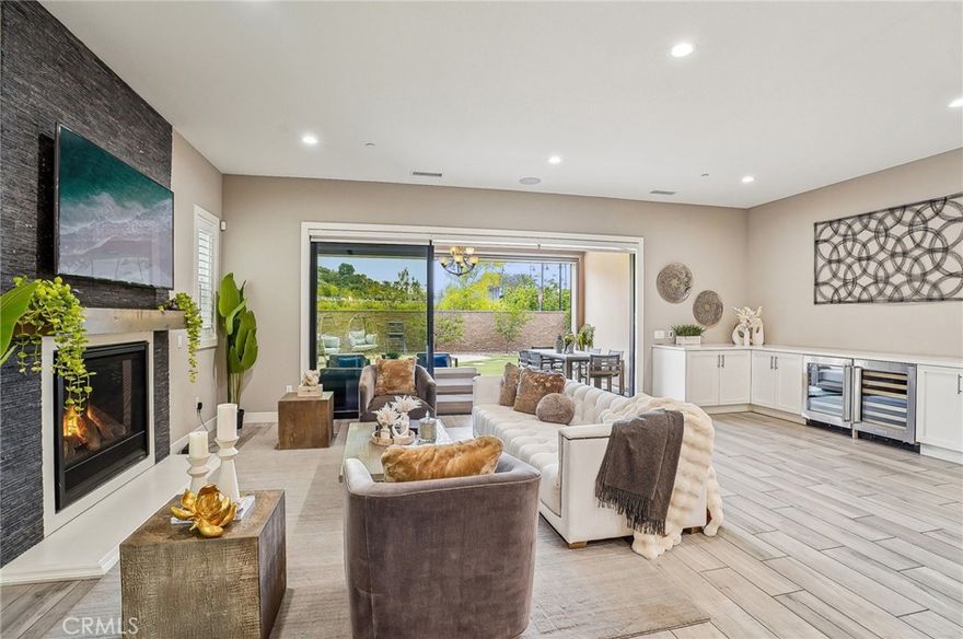 Discover this beautifully crafted home in the prestigious gated community of Avila at Porter
Ranch, where luxury, energy independence, and peace of mind come together. The grand
entryway features custom stone walls and a warm wood ceiling, setting the tone for a
residence that blends elegance and comfort. Inside, the open floor plan offers 4 spacious
bedrooms, 4 bathrooms, and a versatile loft, all framed by soaring 10-foot ceilings on the main
level and designer railings along a sweeping staircase.
At the heart of the home, the gourmet kitchen impresses with quartz countertops, a built-in
refrigerator, soft-close cabinetry, a walk-in pantry, and an oversized island ideal for gatherings.
The great room’s 15-foot stacking sliding doors open to a covered outdoor lounge, creating
seamless indoor-outdoor living enhanced by a cozy fireplace and automatic window shades.
Upstairs, the primary suite serves as a tranquil retreat with a private balcony and mountain
views, a custom walk-in closet, and a spa-like bath featuring dual vanities, a soaking tub, and an
oversized shower with surround sound.
Designed for energy efficiency and resilience, the home includes a fully paid Tesla solar system
with 20+ panels and three Tesla Powerwall batteries, often yielding zero electrical costs under
normal use.
Security and comfort are elevated with Riot Glass reinforced sliding doors on both levels,
security film on all windows, and a Campbell Security steel-reinforced side garage door.
Motorized patio and balcony screens allow fresh airflow while maintaining privacy. A whole-
house water softener, air-scrubber system, and polished concrete finishes add quality and
value.
Residents of Avila enjoy exclusive access to a resort-style pool, spa, cabanas, and a private
banquet room, surrounded by top-rated schools, parks, and The Vineyards at Porter Ranch for
premier shopping and dining.
This home delivers the ultimate blend of security, sustainability, and sophistication.