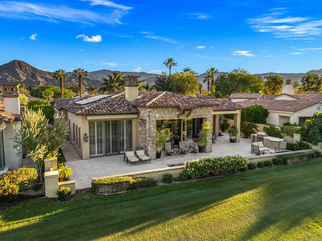 Experience the epitome of desert luxury in this beautifully reimagined 4,064 sq. ft. residence at Toscana Country Club, showcasing over $600,000 in designer-led renovations. Currently offered at the lowest price per square foot in the community, this home presents an extraordinary opportunity to own a refined retreat with timeless sophistication.A seamless blend of transitional and contemporary design defines the interiors, where wood-inspired plank flooring, matching granite and quartzite surfaces with dramatic waterfall edges, and thoughtfully curated finishes set the stage. The open courtyard welcomes with a tranquil water feature, putting green, firepit, and dual sets of triple-pane doors that invite natural light and effortless indoor-outdoor living.The expansive great room is designed for both grand entertaining and intimate gatherings, featuring dual pocket doors framing double-fairway views of the Jack Nicklaus Signature Golf Course, a statement fireplace with adjacent wet bar, and multiple sitting areas.The chef's kitchen is a true showpiece, anchored by an impressive L-shaped waterfall island with breakfast bar, modern wood-grain cabinetry, pot filler, and top-tier appliances including a panel-matched refrigerator, dual ovens, professional-grade range and hood, and a full-size wine refrigerator.Retreat outdoors to enjoy a private spool with water feature, a second firepit, and serene spaces to savor desert evenings.The master suite is a sanctuary, complete with a spacious bedroom and private lounge. Its spa-inspired bath features dual waterfall-edge vanities, a quartzite-wrapped soaking tub set against a custom feature wall, and a glass-enclosed shower with luxurious stone finishes.Two additional guest suites (one currently used as an office) and a detached private casita with kitchenette provide comfort and privacy for visitors.This exceptional residence balances refined elegance with modern amenities, including owned solar, creating the ultimate desert lifestyle at one of Indian Well's most prestigious addresses.