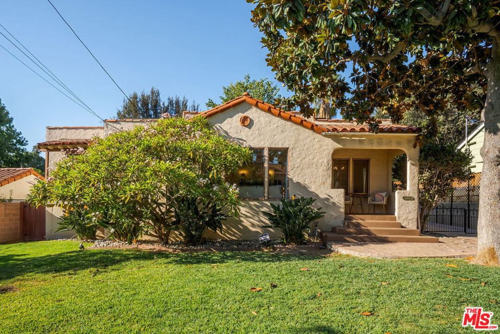 A Rare 1930 Spanish Revival Gem with Timeless Character and Modern Comforts. Step into history with this original 1930 Spanish Revival home, a rare offering that blends timeless craftsmanship with thoughtful modern updates. This residence boasts four bedrooms and two bathrooms, with an architectural story that unfolds at every turn. The living room sets the stage with a wood-burning fireplace, dramatic picture windows, a charming window seat with hidden storage, and an original built-in secretary desk. Adding to its distinction are the home's one-of-a-kind bi-fold casement windows, a feature so unique that even historic window specialists have rarely seen anything like them. French doors with original hardware open gracefully into the dining room, creating a seamless flow for gatherings. Throughout the original structure, plaster walls remain intact, preserving the home's authentic character. The kitchen and original bath have been tastefully remodeled, preserving charm while offering everyday functionality. A Viking stove and hood fan, along with a new stainless steel dishwasher complete the setting. A significant 1990 addition expanded the home to include a versatile fourth bedroom with a private balcony (currently serving as a home office), a laundry room, a basement retreat perfect for entertaining or work, and an expansive owner's suite. This owner's retreat features vaulted ceilings, hardwood flooring, a custom walk-in closet, a spa-like bath with clawfoot tub, a skylight, and its own wood-burning fireplace. Sliding doors lead to a covered deck overlooking the patio, complete with a water fountain and cafe string lights for enchanting evenings. Looking over the private backyard lined with cafe string lights secluded from the outside world, it is an entertainer's dream. The grounds are as captivating as the interiors. This beautifully landscaped property offers year-round enjoyment with an array of trees and flowering plants. The rear yard showcases a stately mulberry tree shading the paver patio and fountain, along with three mature trees (grapefruit, macadamia nut, and lime), and three younger trees, yet fruit-bearing, one being a lemon and two peach trees. Four rose bushes bring vibrant color throughout the year. In the front yard, lush landscaping includes birds of paradise, a large mature plumeria, crepe myrtle, magnolia, and a striking Golden Trumpet tree. Recent updates bring peace of mind: seismic bracing and foundation reinforcement (2023), termite treatment with warranty, new landscaping front and rear with gated entry, new dishwasher (2025), updated bath fixtures (2025), carpeting in the basement (2022), pest-proofing (2022), and seasonal HVAC servicing. Located on one of the last streets served by The Whittier Cruiser, a free all-electric shuttle connecting you to Uptown Whittier, Rodeo 72 Public Market, and more, the home offers unbeatable convenience. Uptown Whittier, with its charming main street, features a vibrant local restaurant and business culture, and throughout the year hosts numerous community events that celebrate its unique spirit. Parks and trails are nearby, including Hellman Wilderness Park and the Whittier Greenway, while I-605 access is less than 10 minutes away. This home is not just a residence, it is a piece of Whittier's history, a showcase of rare craftsmanship, and a sanctuary of comfort for modern living.