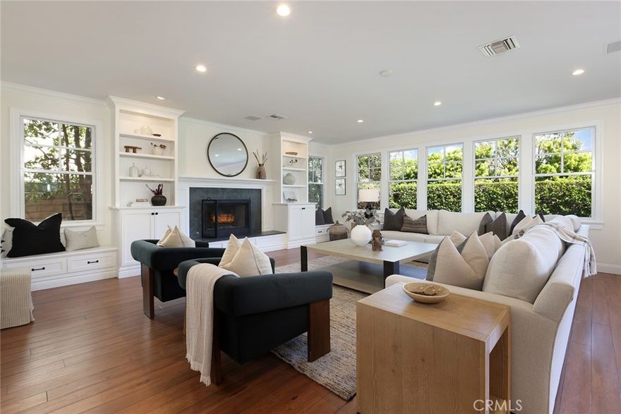 Completely remodeled and thoughtfully curated, 1730 Port Abbey is a stunning 4-bedroom, 4-bathroom residence in the heart of Newport Beach’s sought-after Port Street neighborhood. Set on an oversized lot on a tree-lined street, this home combines timeless charm with high-end designer touches throughout. From the moment you step through the idyllic Dutch door, you'll notice the attention to detail and quality craftsmanship. The main level features a formal living room with French doors that open to a welcoming front porch, a dining room with custom built-ins, and an extra-large family room with fireplace and seamless indoor-outdoor flow to the backyard. At the heart of the home is a fully remodeled chef’s kitchen, showcasing quartz countertops, all-new top-of-the-line appliances, dual dishwashers, a walk-in pantry, and an oversized island with seating—perfect for entertaining. The bathrooms have been beautifully updated with high-end finishes, and the entire home is adorned with designer light fixtures and new window coverings. A main-floor bedroom and bath offer flexibility for guests or a home office. Upstairs, two spacious guest suites each feature updated ensuite baths, along with a large laundry room. The serene primary suite includes a spa-like bathroom and a generous walk-in closet. Freshly painted inside and out, and offering a 3-car garage, this turnkey home is an exceptional opportunity to live in one of Newport Beach’s most desirable communities.