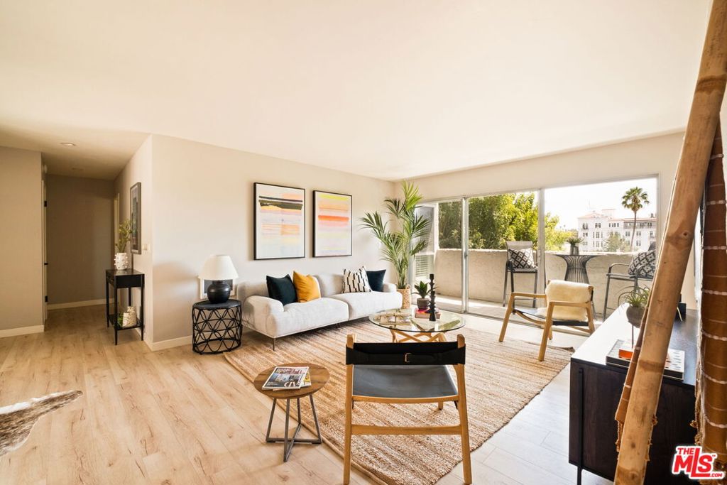 Welcome to one of West Hollywood's most desirable locations, combining central convenience with quiet residential charm. This tasteful condo offers an open, light-filled floor plan with a galley kitchen, dining area, and direct east-facing views of Downtown Los Angeles from both the living room and private terrace. The two bedrooms and baths are thoughtfully positioned on opposite sides of the home for maximum privacy, while generous closet space provides excellent storage. Building amenities include a ground-level pool and spa, landscaped common areas, and a rooftop deck with sweeping city views. Two side-by-side parking spaces in the secure gated garage and ample guest parking complete this exceptional offering.