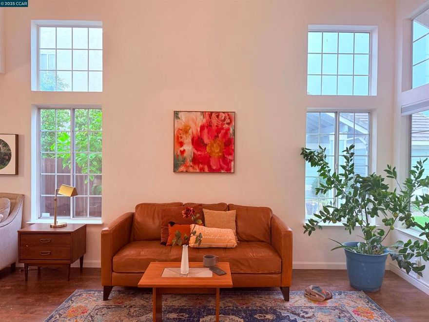 Fall in love with this charming, beautifully maintained two-story home filled with natural light and warm, inviting spaces. Soaring vaulted ceilings welcome you into the bright formal living and dining rooms, where large windows create an open, airy feel. The updated kitchen features white cabinetry, stainless steel appliances, and plenty of workspace, opening comfortably to the cozy family room complete with a fireplace and classic wet bar—perfect for relaxing evenings or gatherings.  A full bedroom and bathroom downstairs offer convenience for guests or multigenerational living. Upstairs, you’ll find generously sized bedrooms and a peaceful primary suite.  The backyard provides a sweet sitting area ideal for morning coffee or quiet sunset moments. Solar panels add modern efficiency, and the home sits on a quiet street just a short stroll from Pittsburg’s charming Old Town and marina.  A warm, welcoming home—ready for its next chapter.